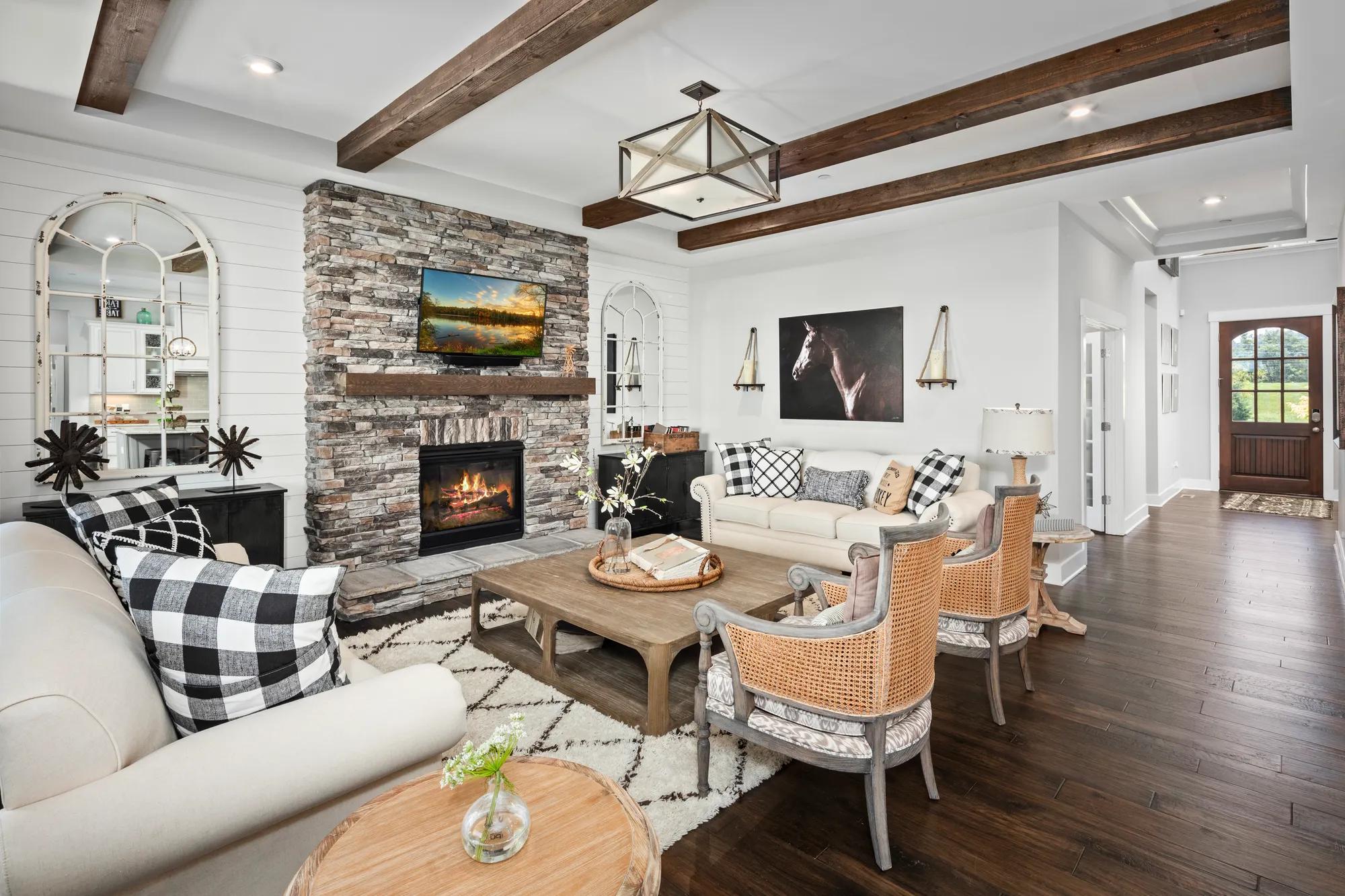 family room with beam ceiling and fireplace