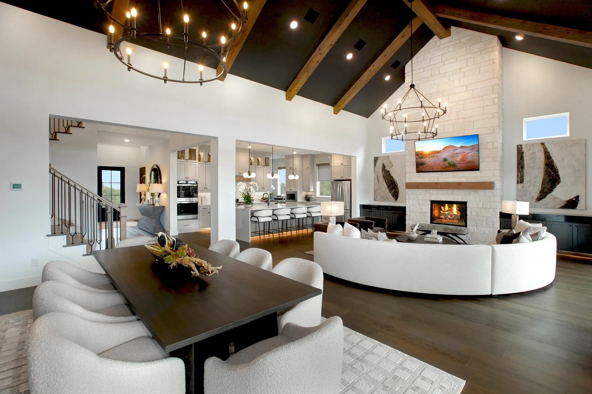 open concept dining and family room with vaulted beam ceiling and fireplace