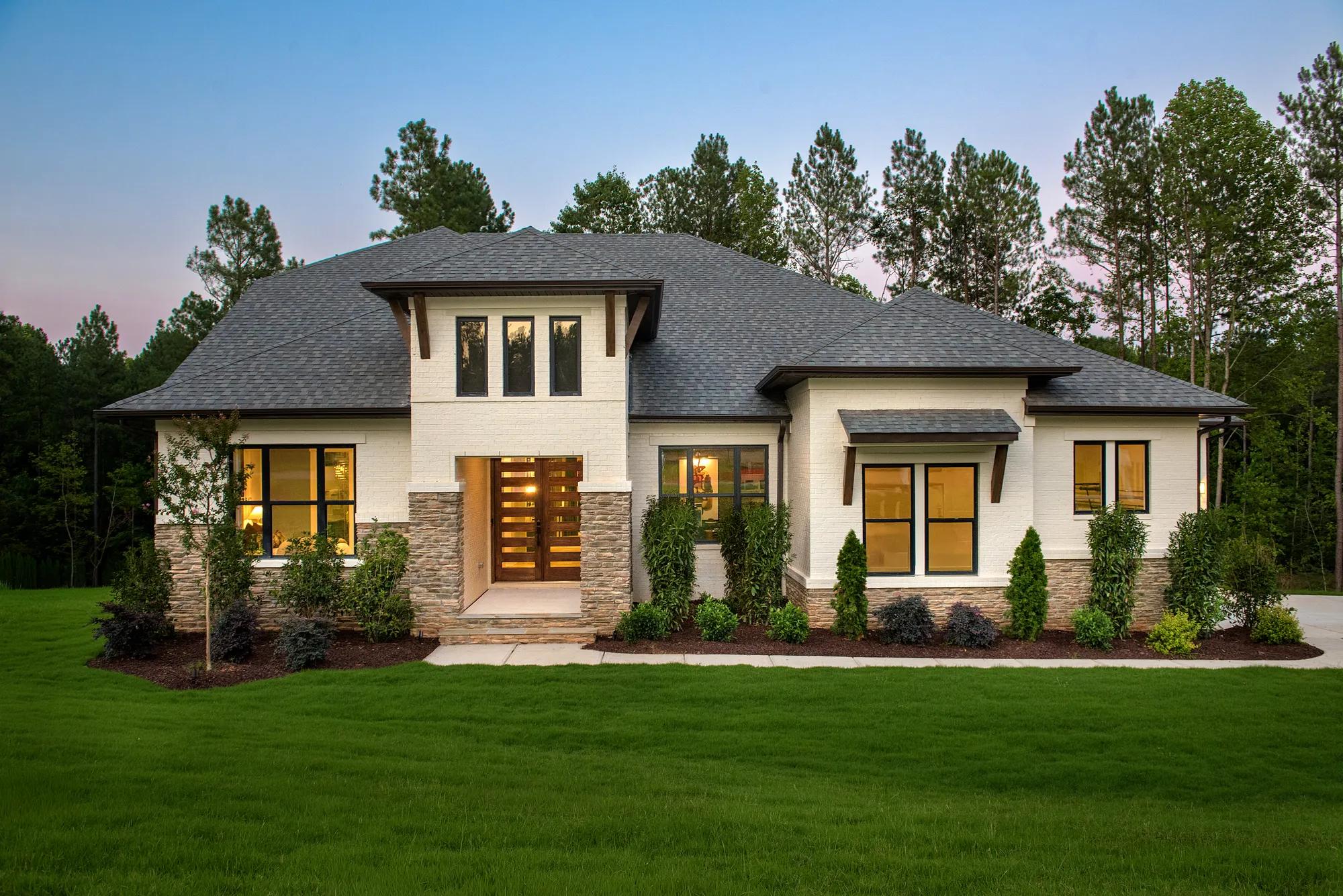 Custom home with cream brick, brown stone, and modern roof lines