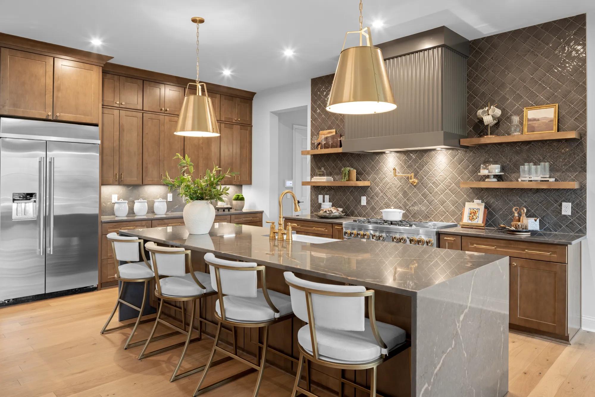 New home kitchen with stainless steel appliances, tile wall backsplash, and waterfall island