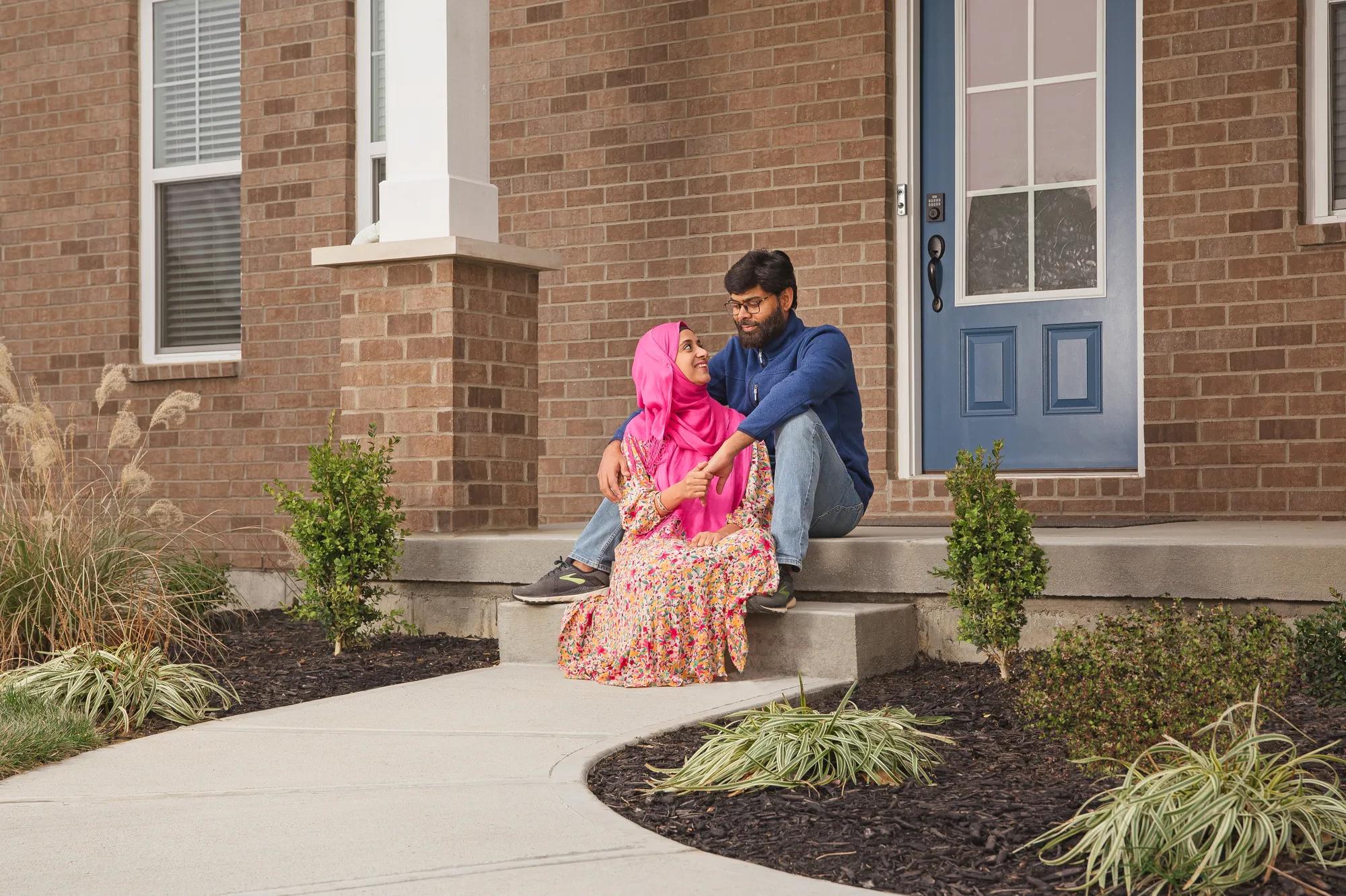 New homeowners in front of the Alwick exterior