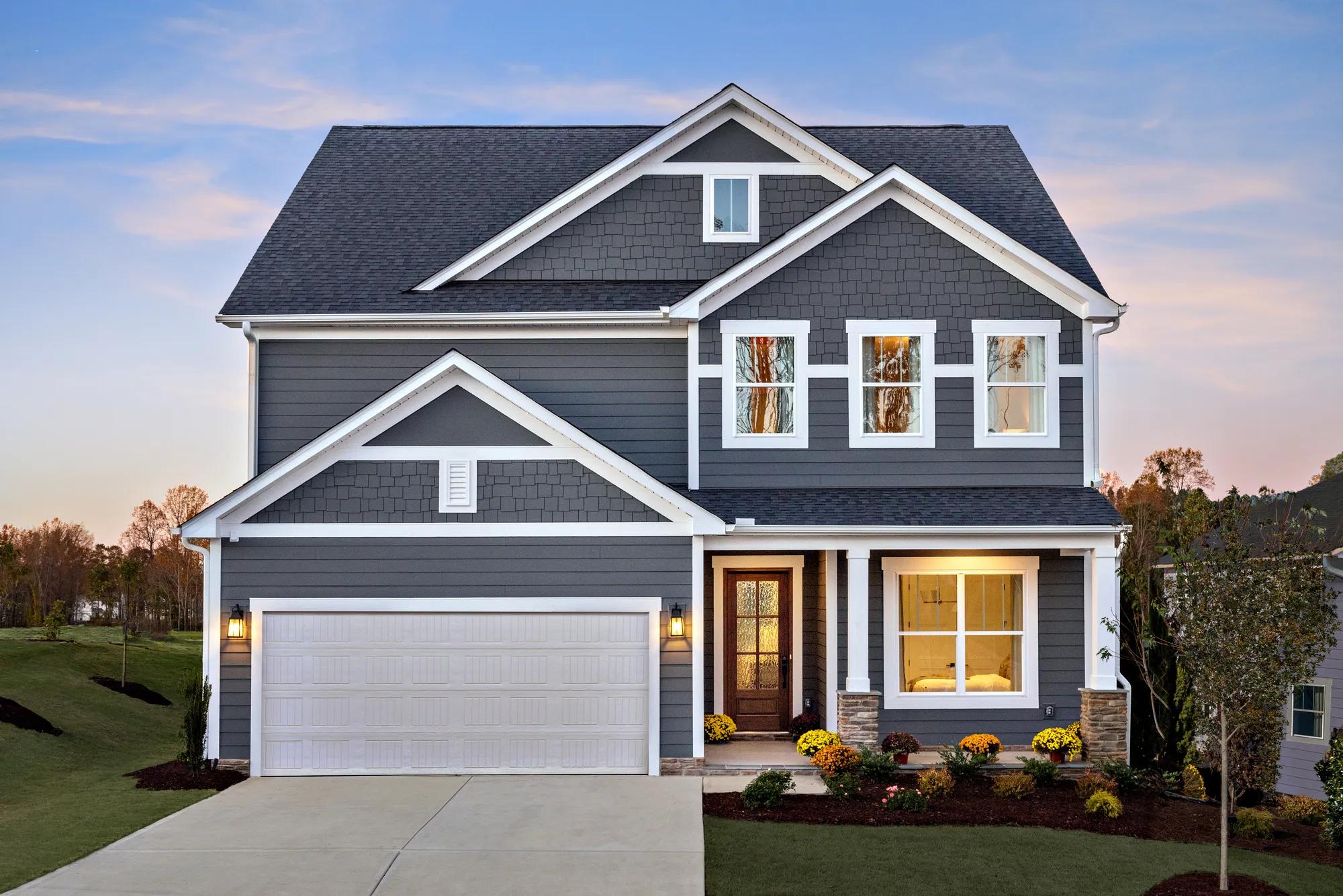 exterior dusk shot of the Horizon with bluish-gray siding, shakes and white trim