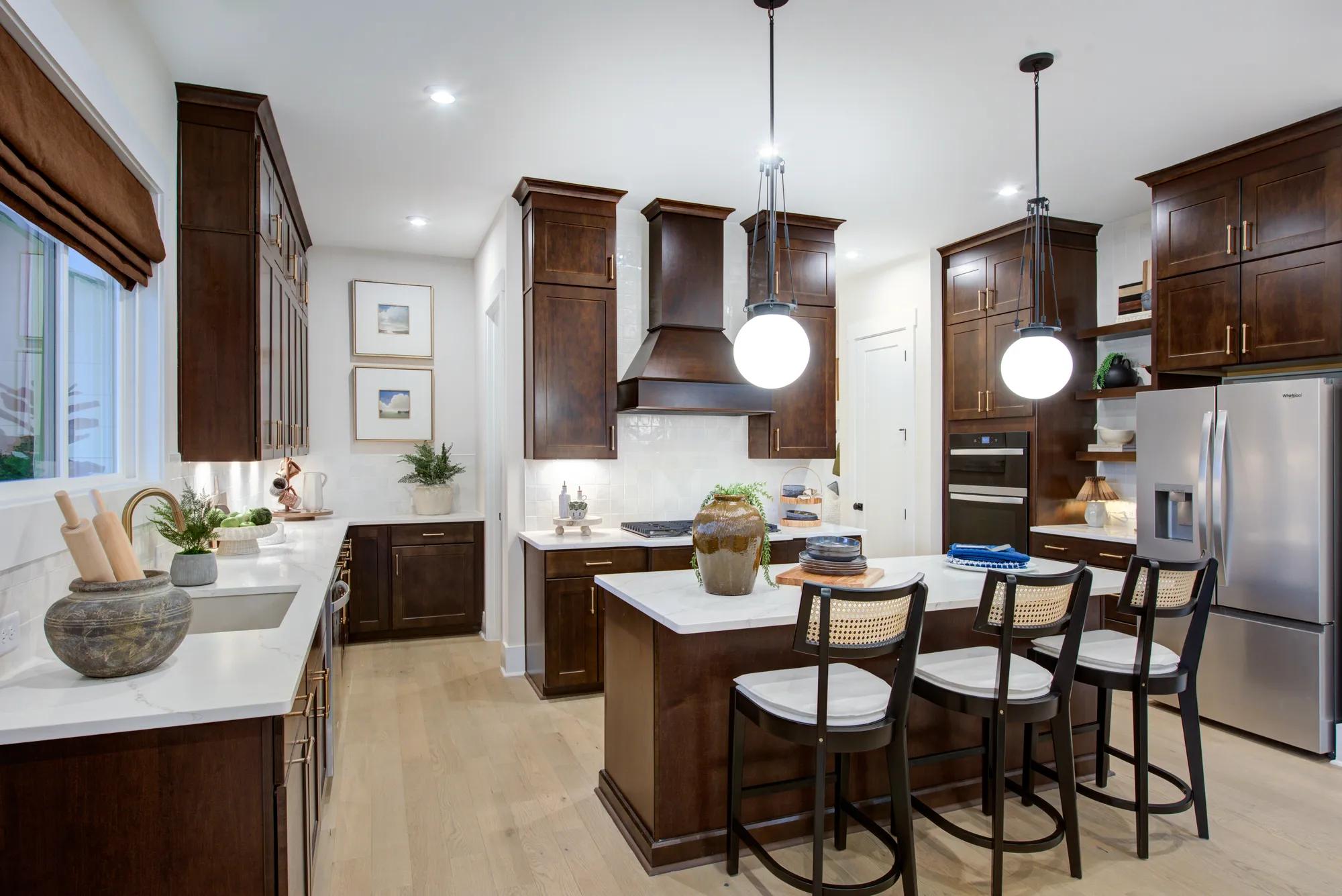 Custom home kitchen with dark wood cabinets and island