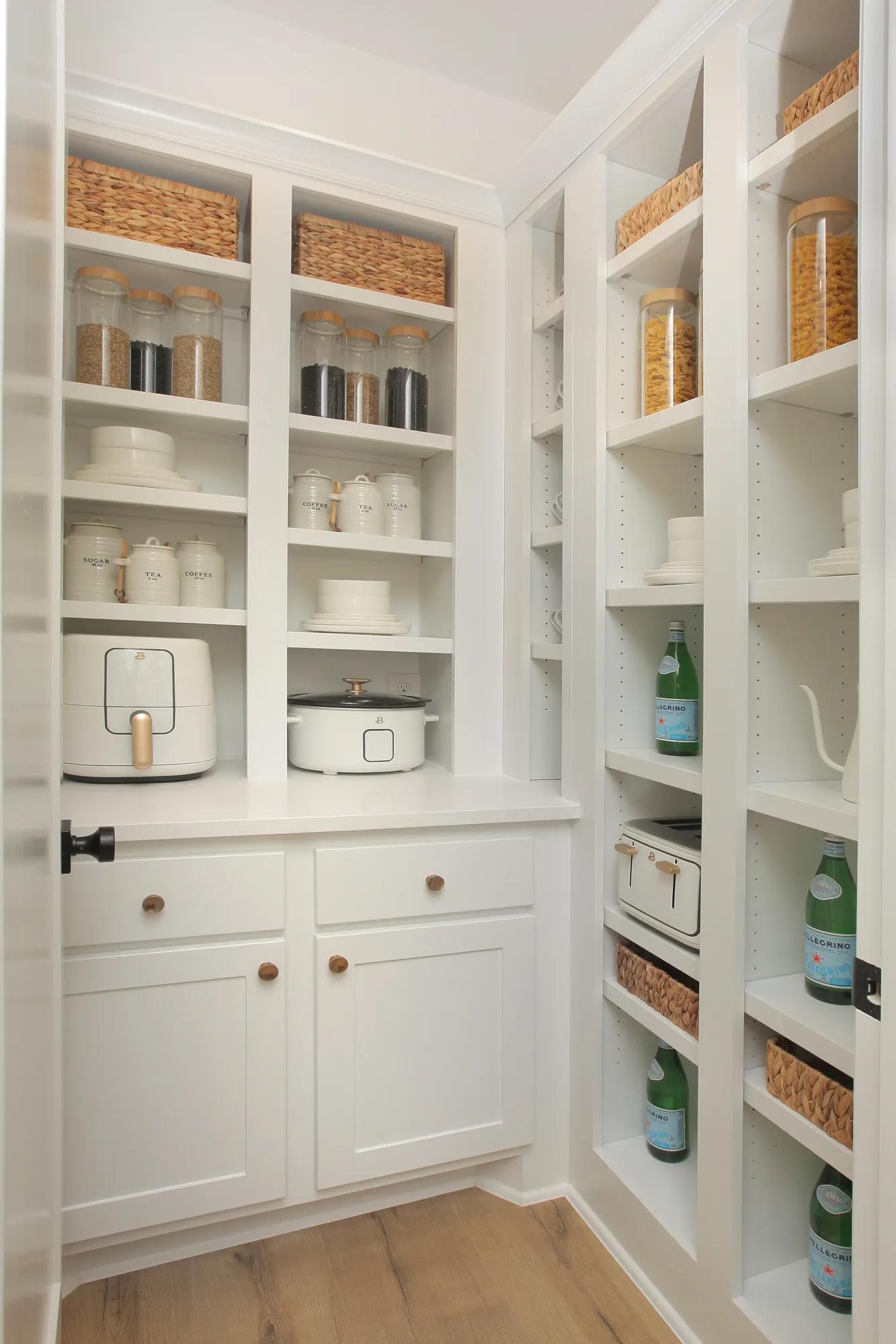 New home working pantry with white cabinets and built in shelves