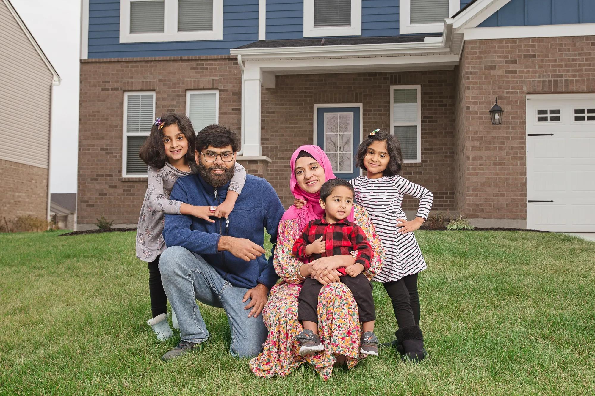New homeowners in front of the Alwick exterior