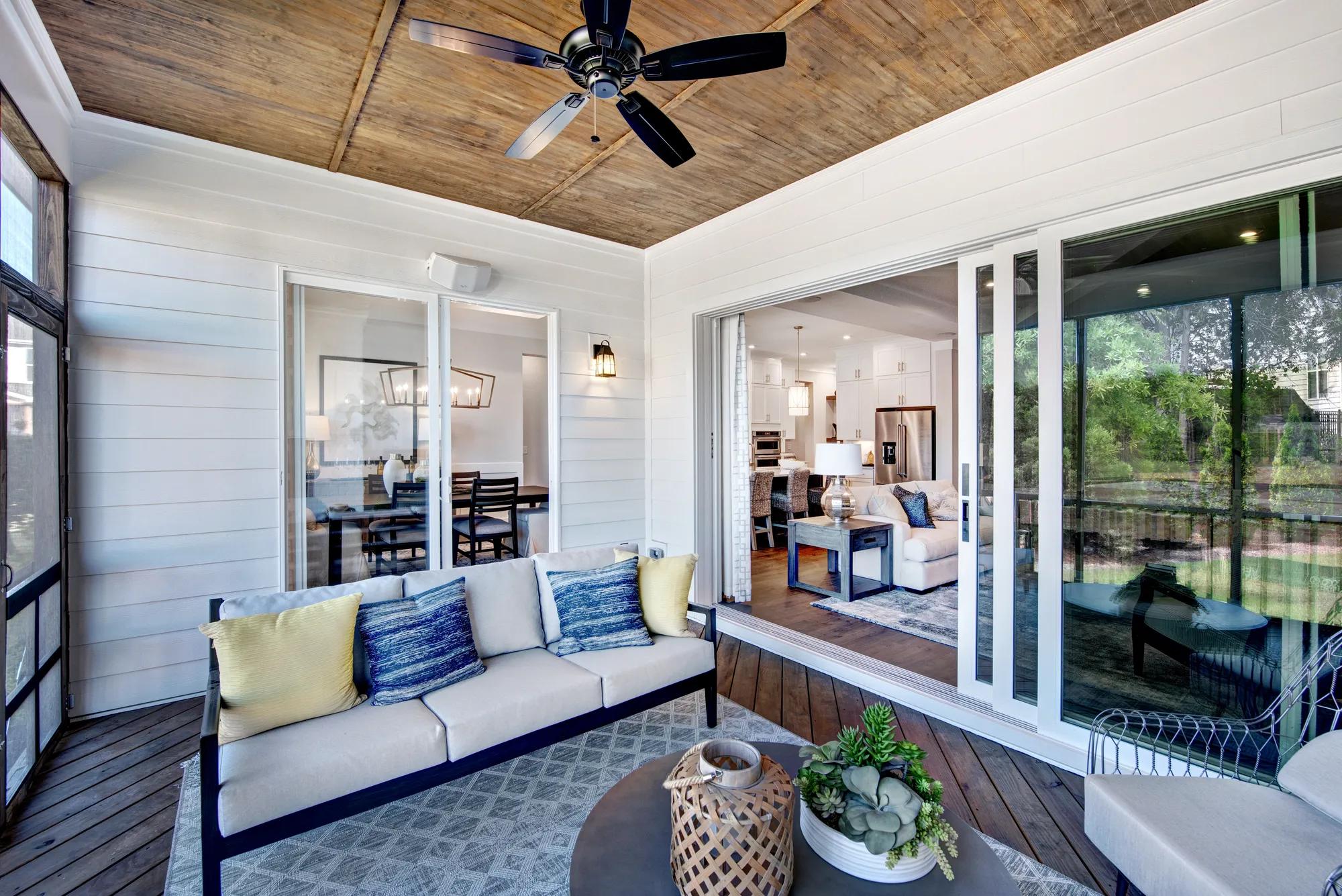 covered porch with two sliding glass doors to family and dining rooms