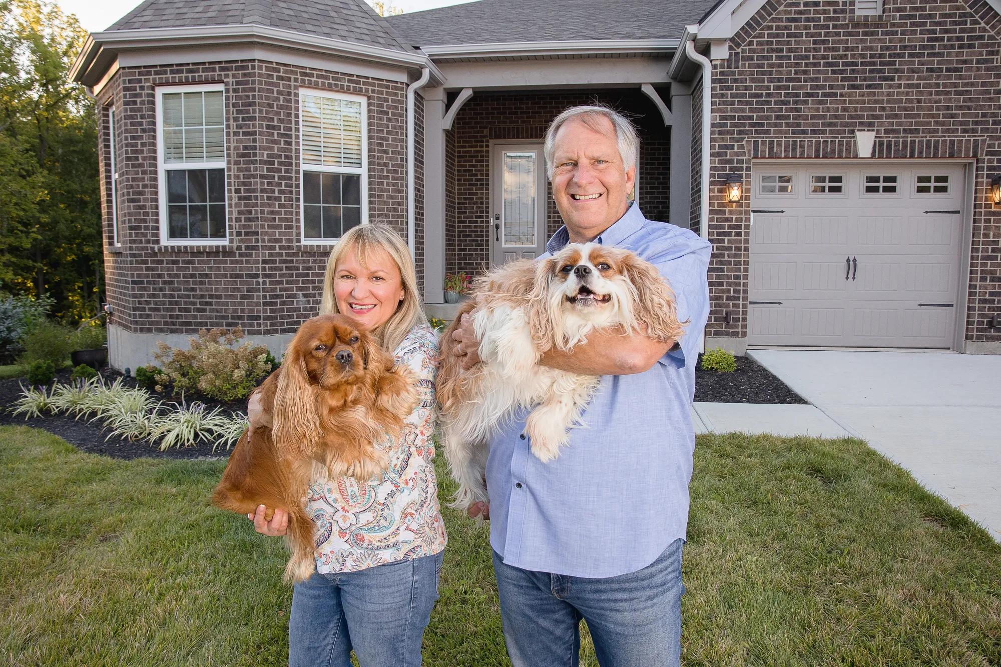 New homeowners outside of their Drees home