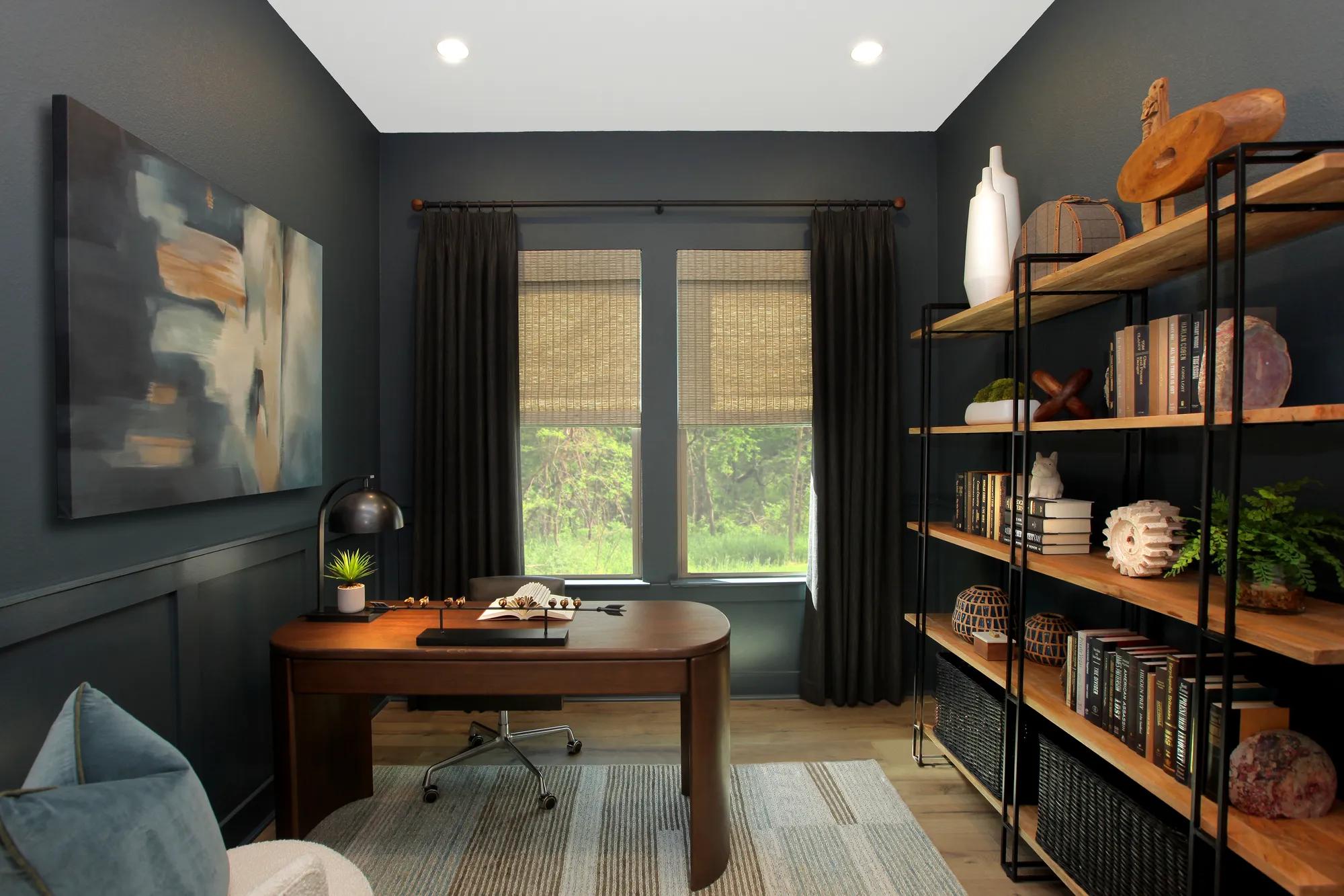 Custom home office with black walls, rich wood furniture, and hardwood floors