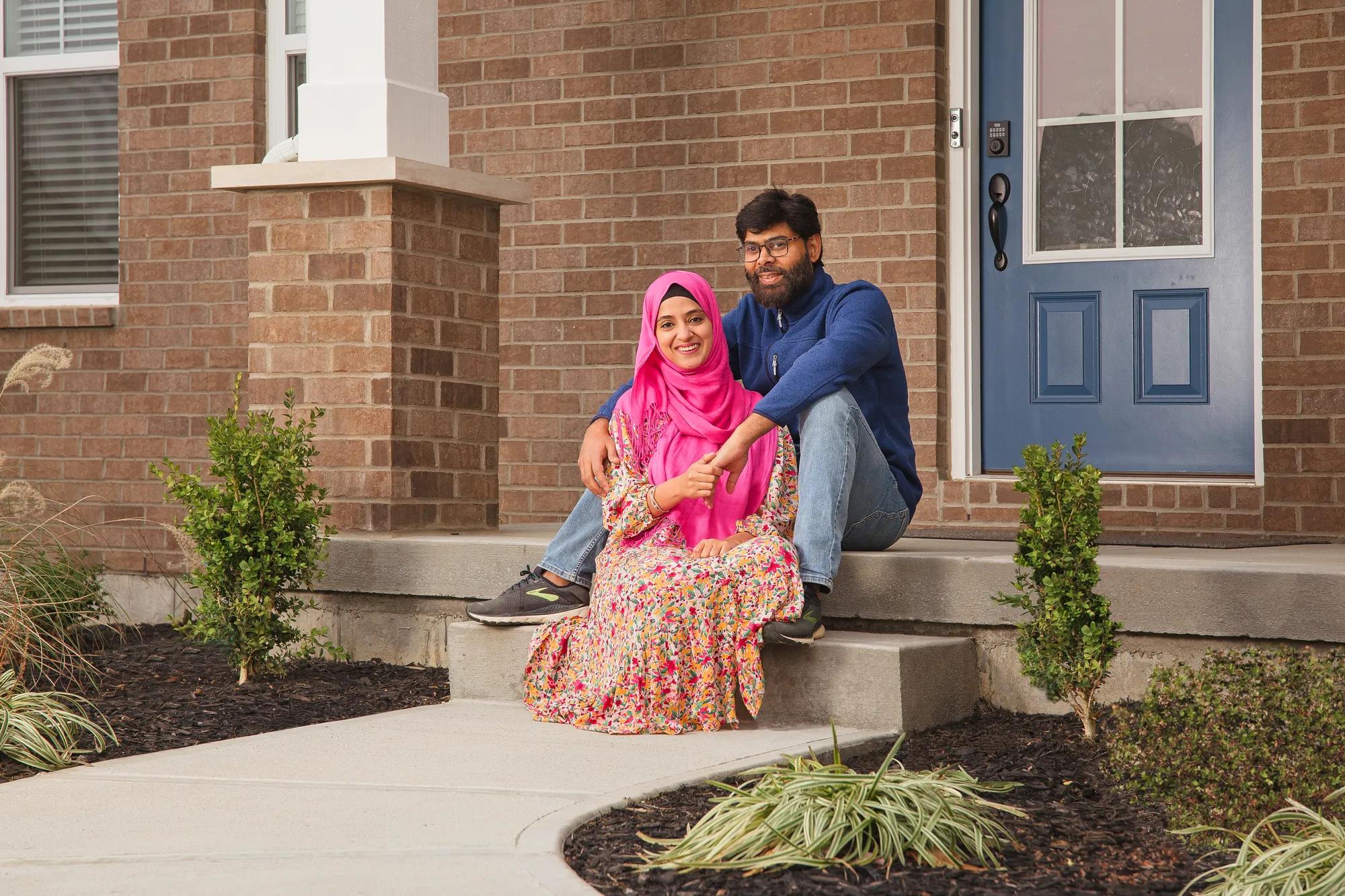 New homeowners in front of the Alwick exterior