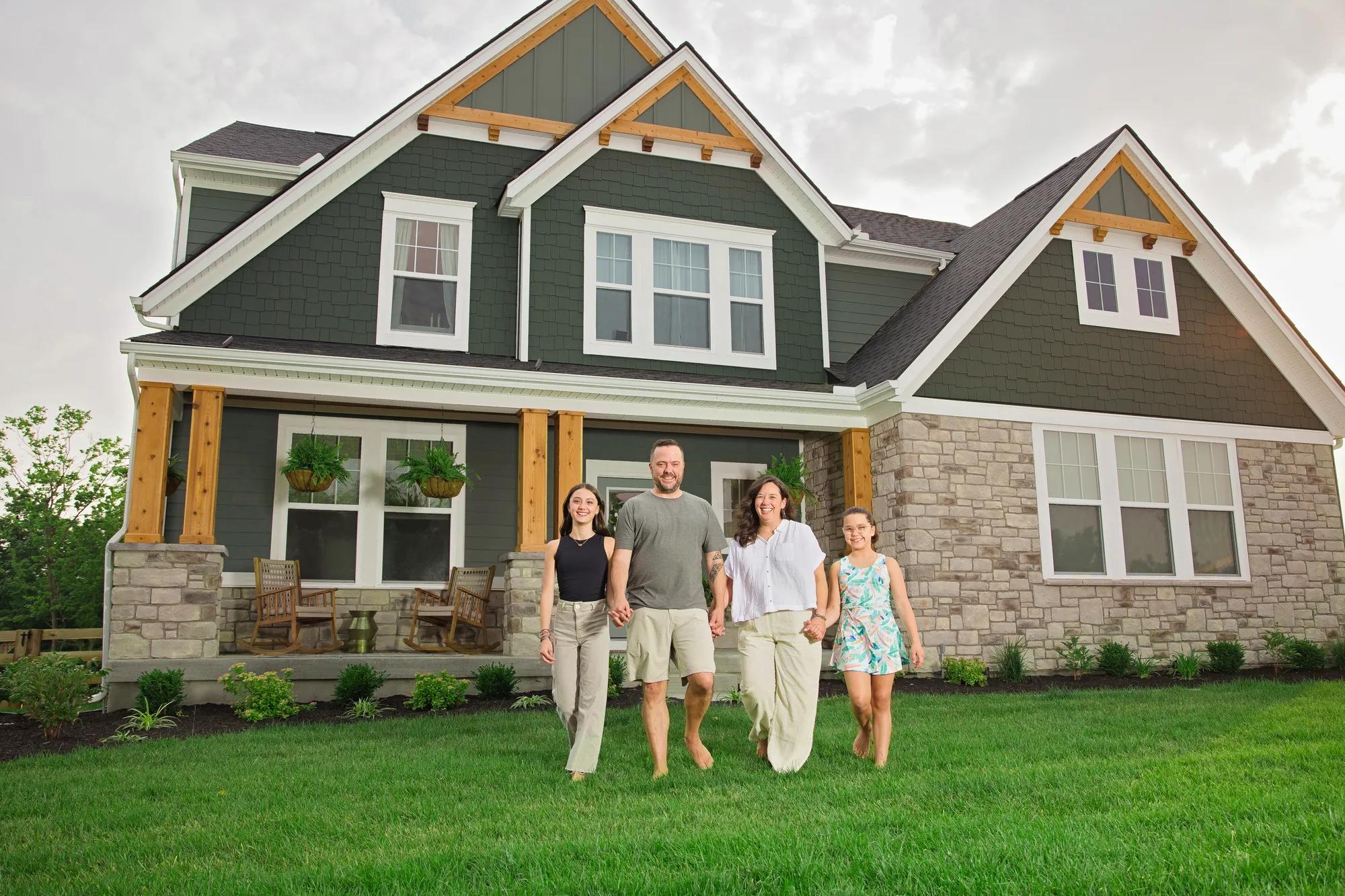 New homeowners outside of their Alden home