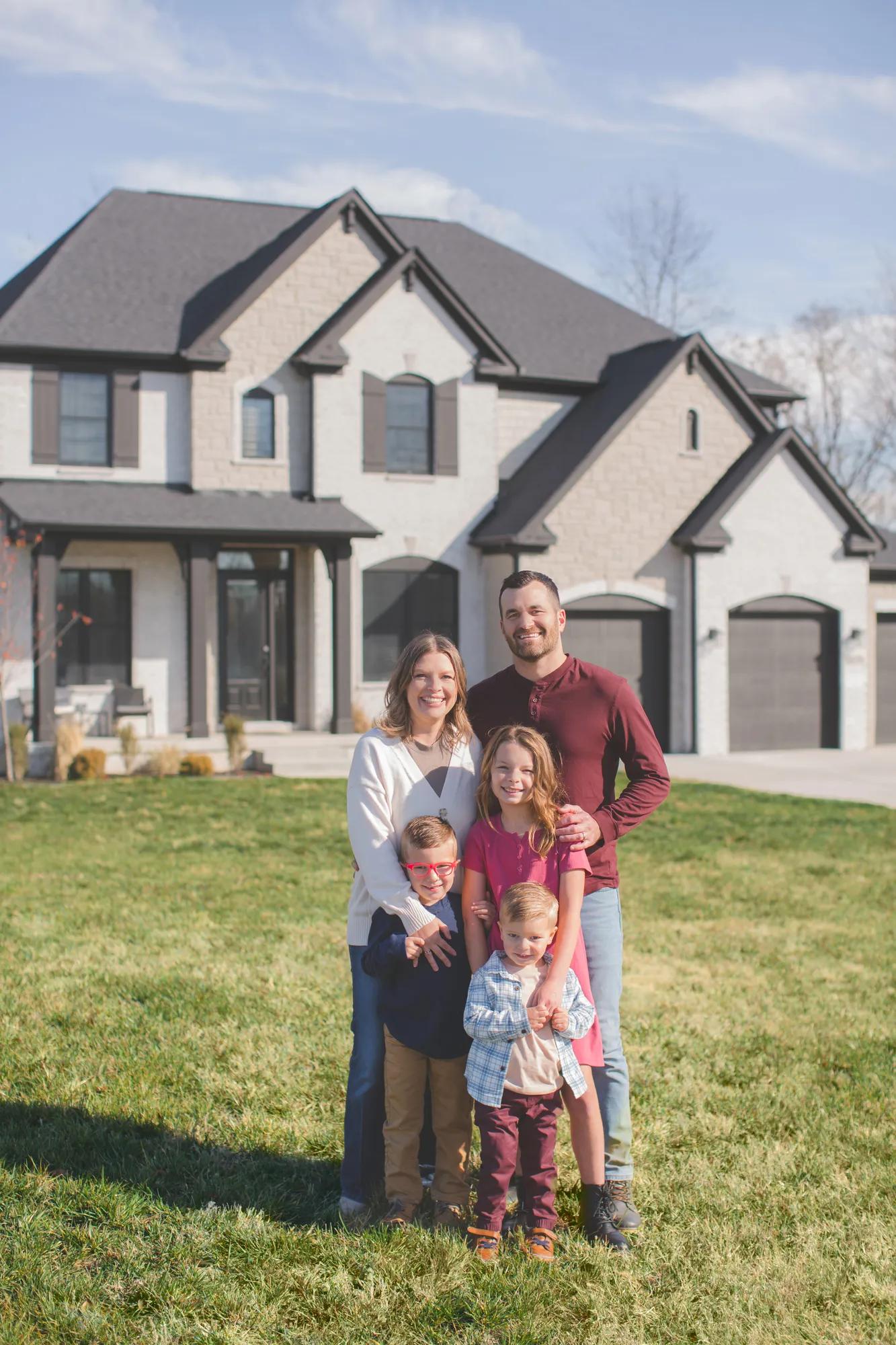 New homeowners in front of their Drees home exterior