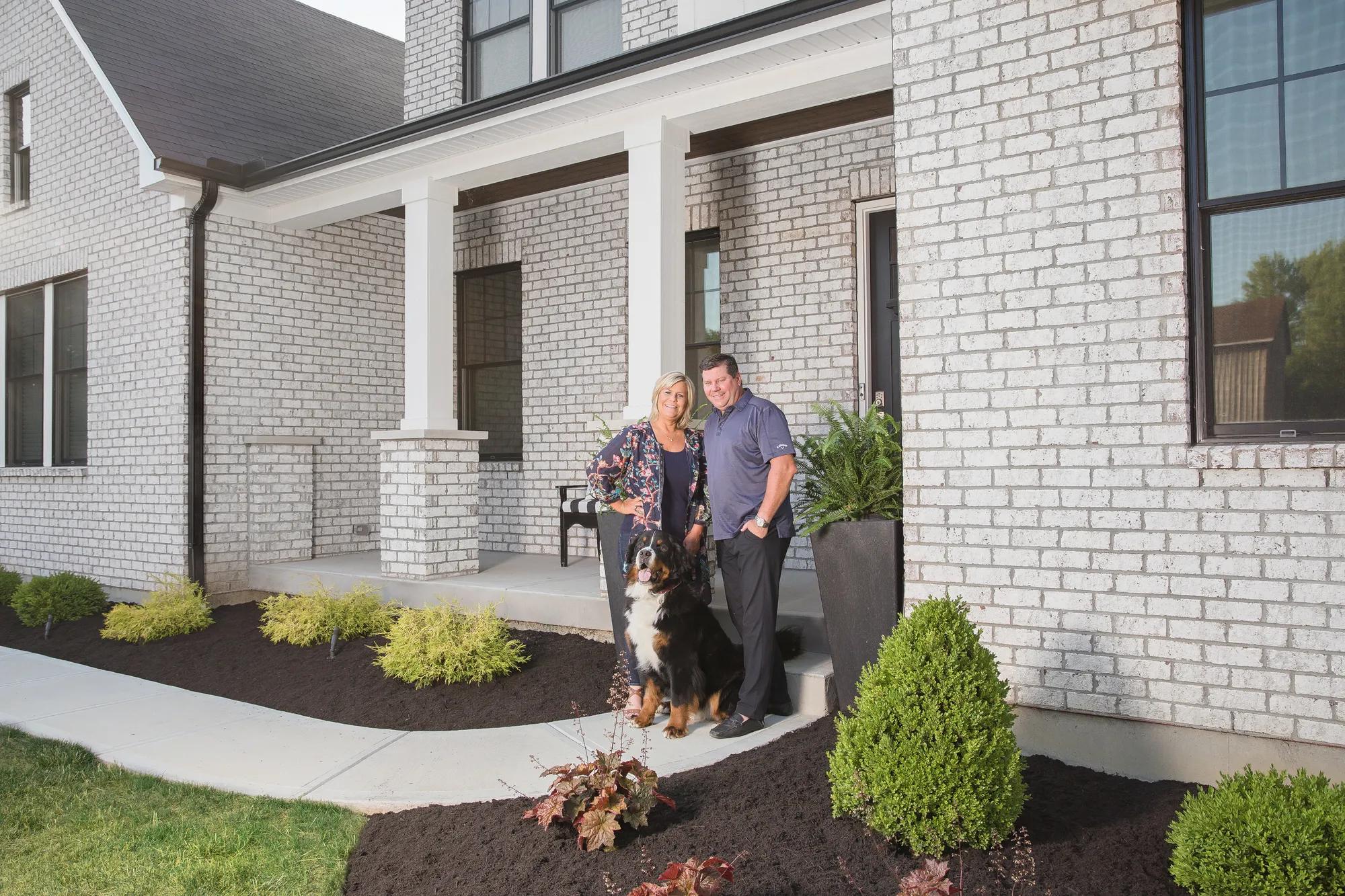 New homeowners enjoying the front porch of their new Drees Home