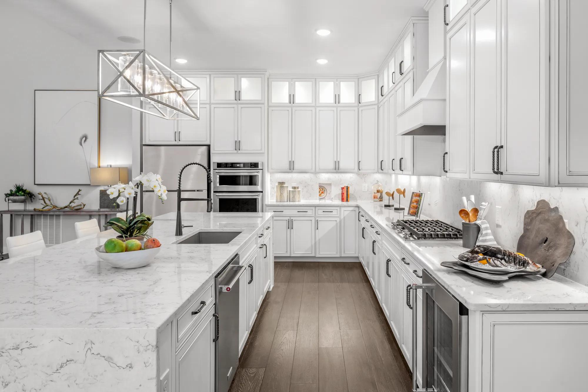 custom kitchen with gas cooktop and white cabinets
