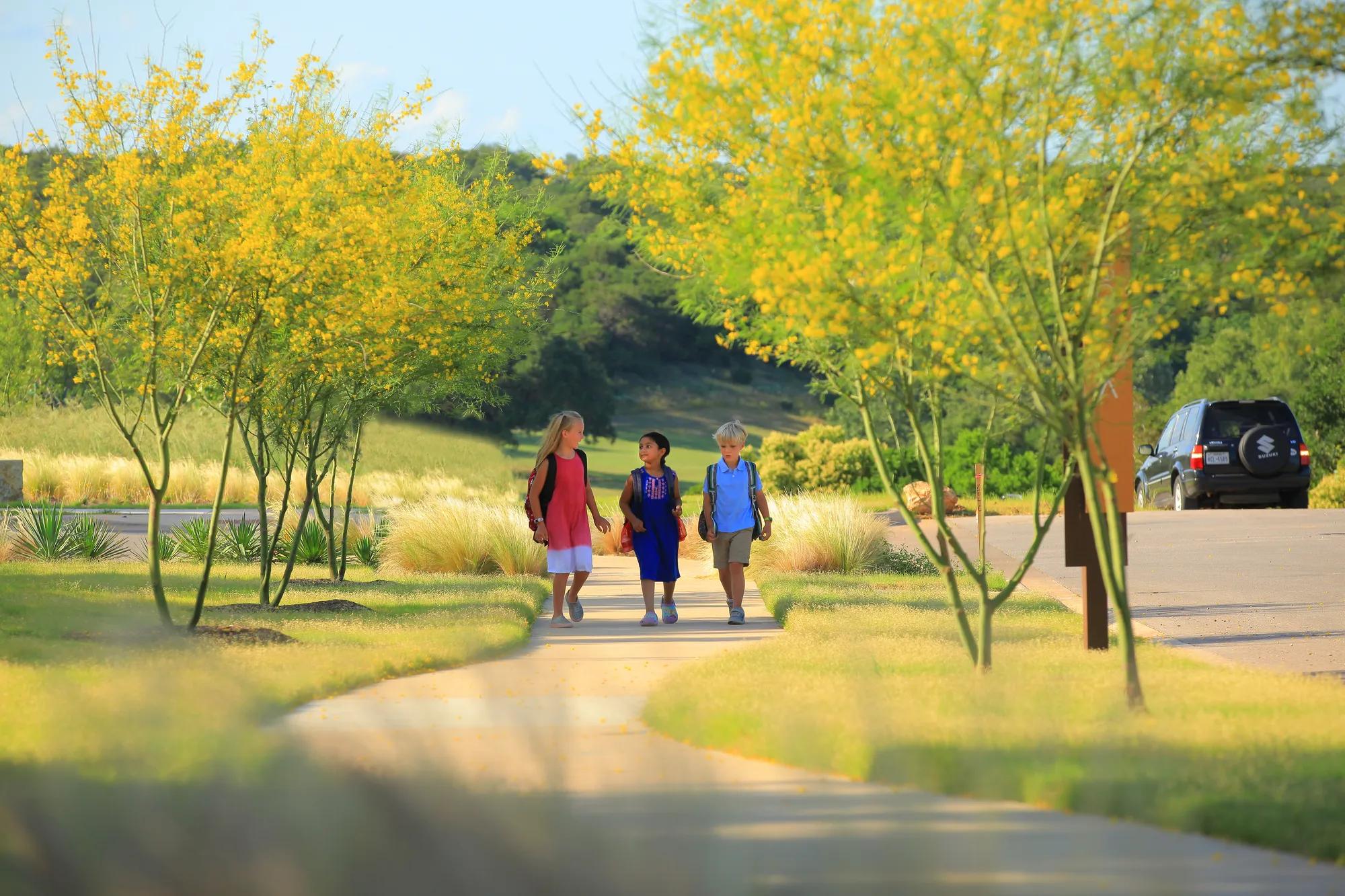 Three kids walking to school