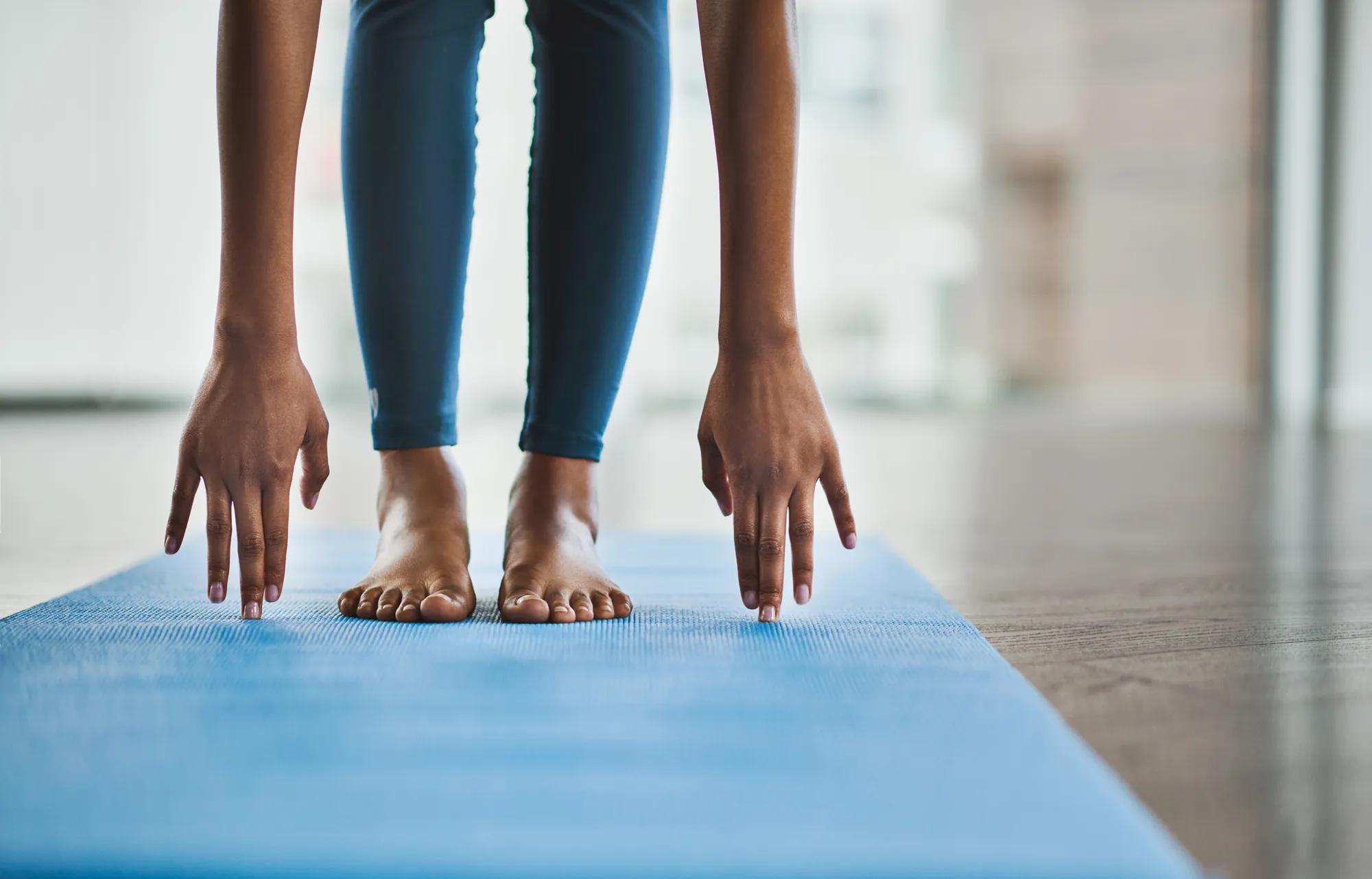 Woman stretching on yoga mat