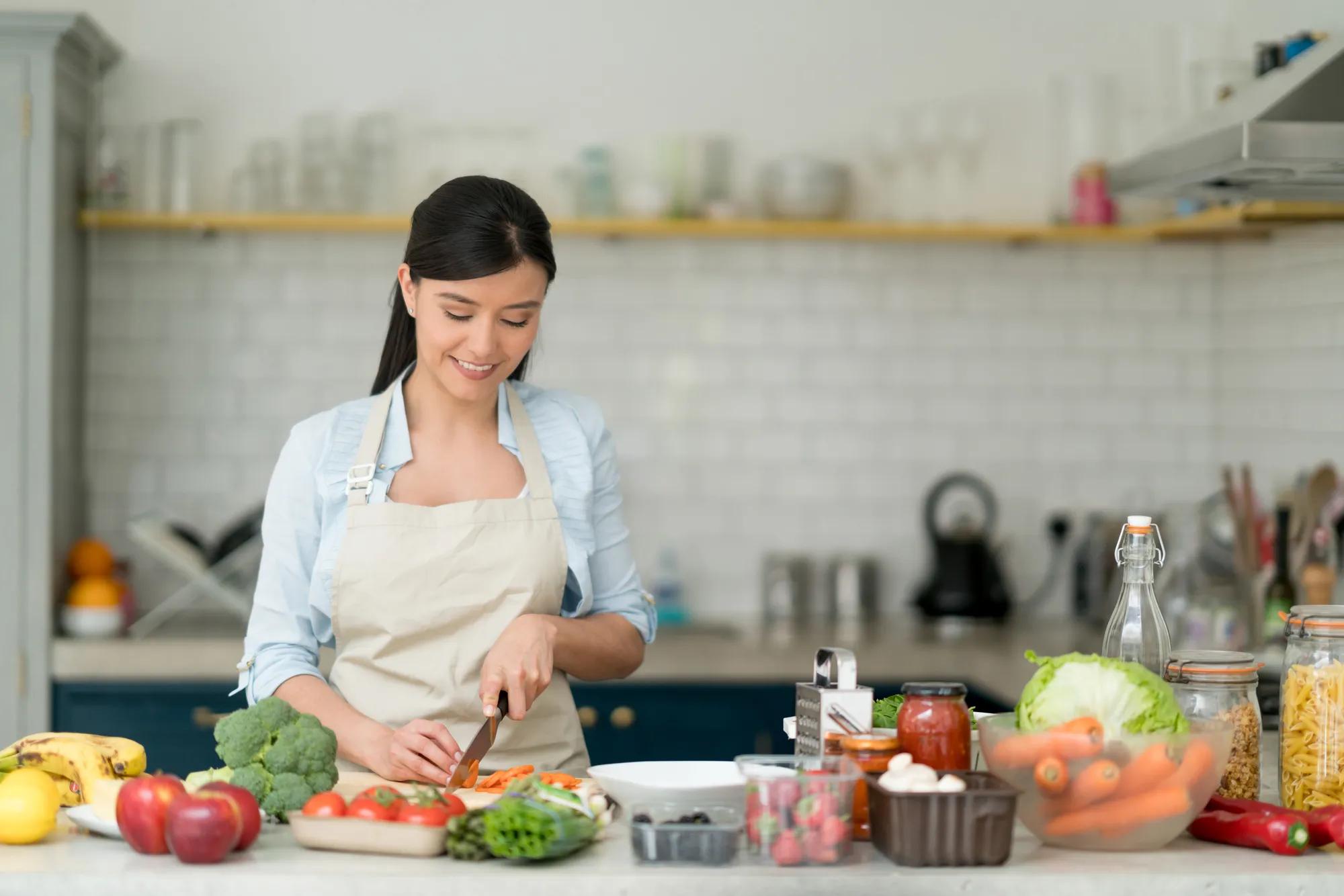 Woman cooking in new home kitchen
