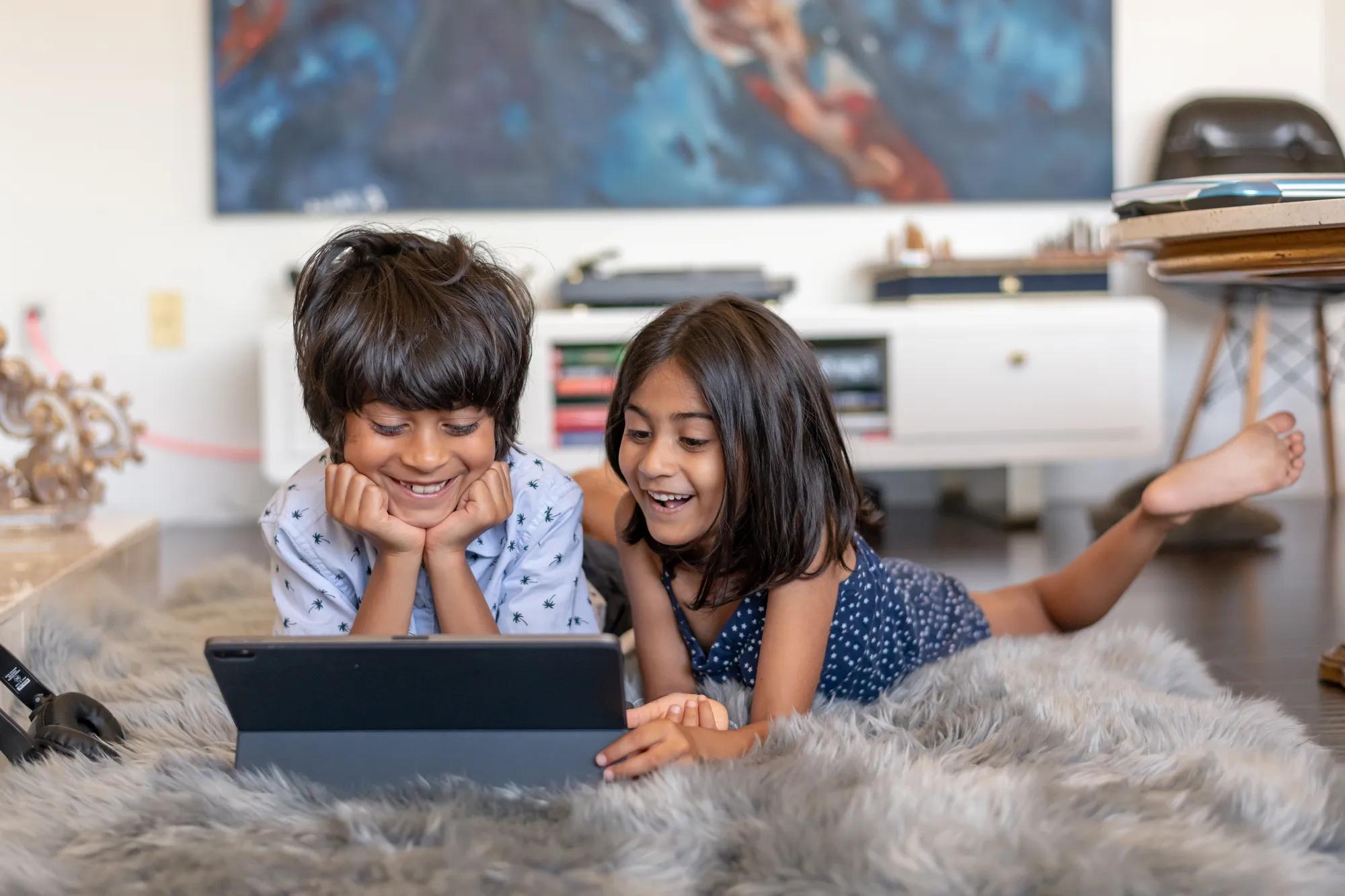 Children enjoying electronics in their new home
