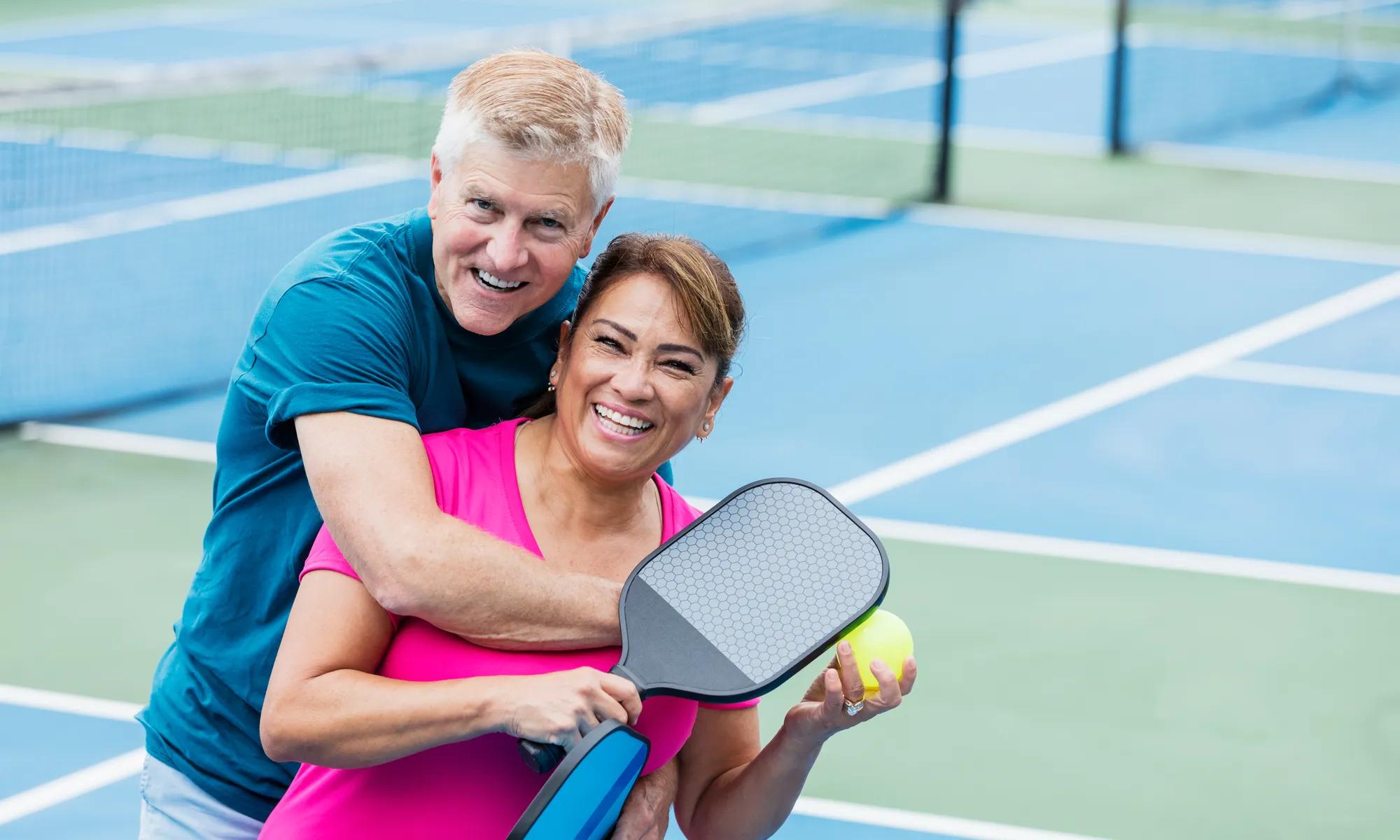 Couple playing on pickeball court