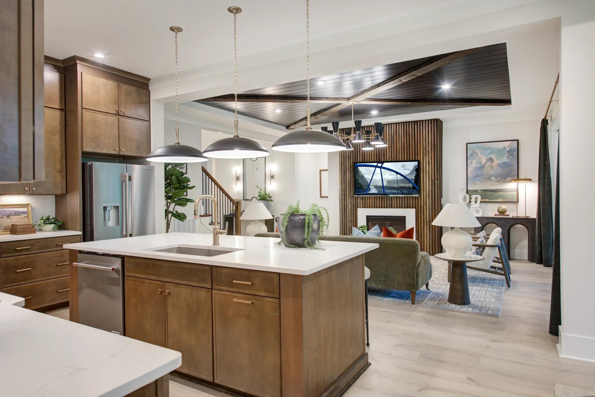 Modern home open floor plan kitchen with island and family room with reed fireplace