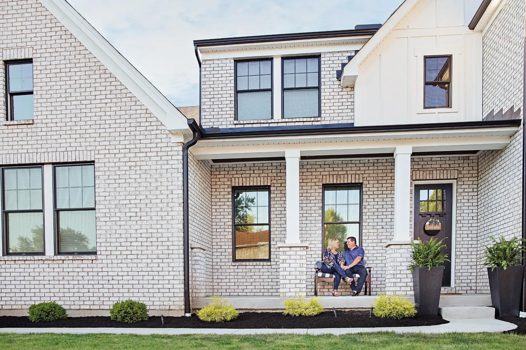 New homeowners enjoying the front porch of their new Drees Home