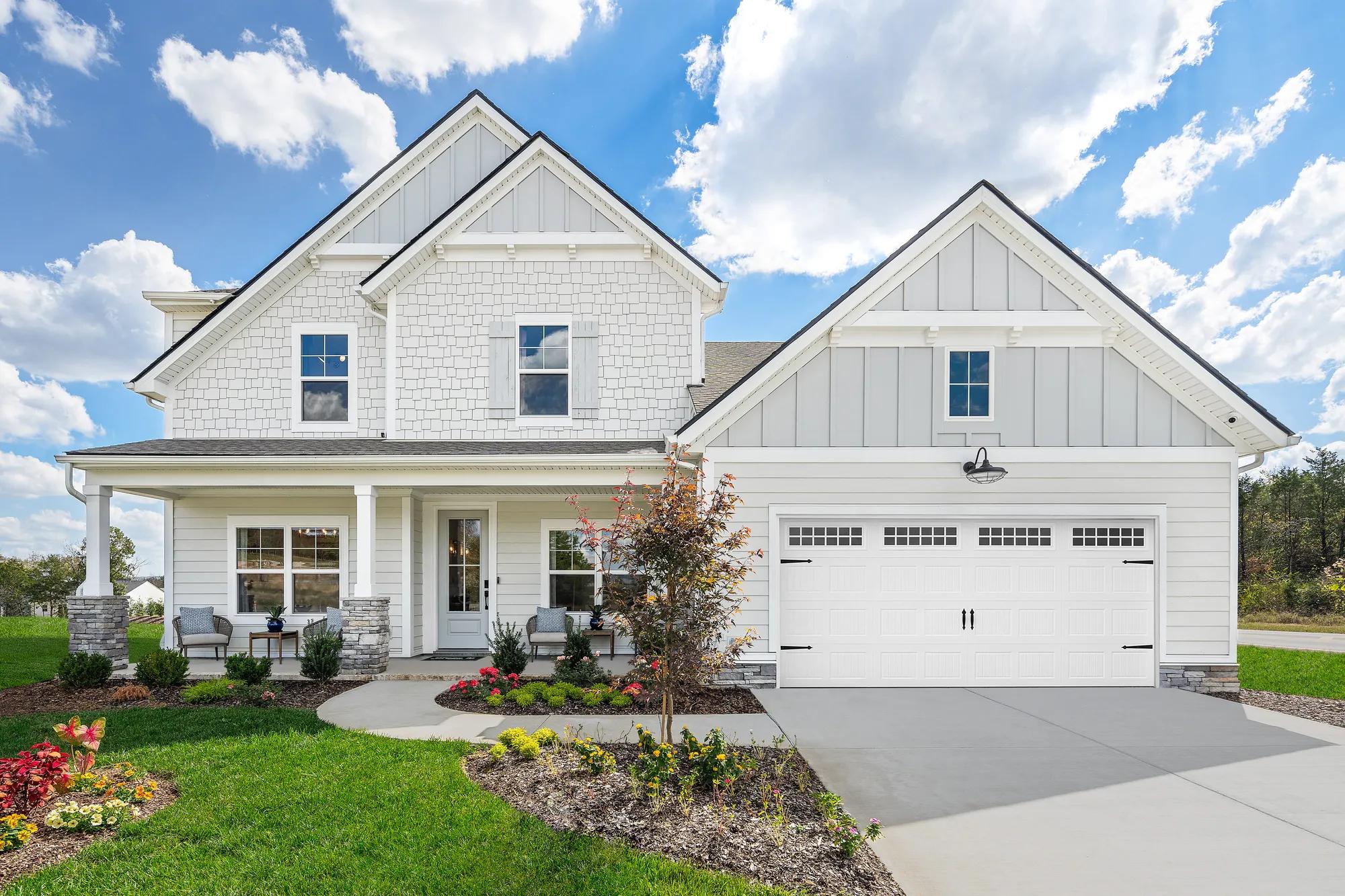 two-story home with shakes, siding and front porch