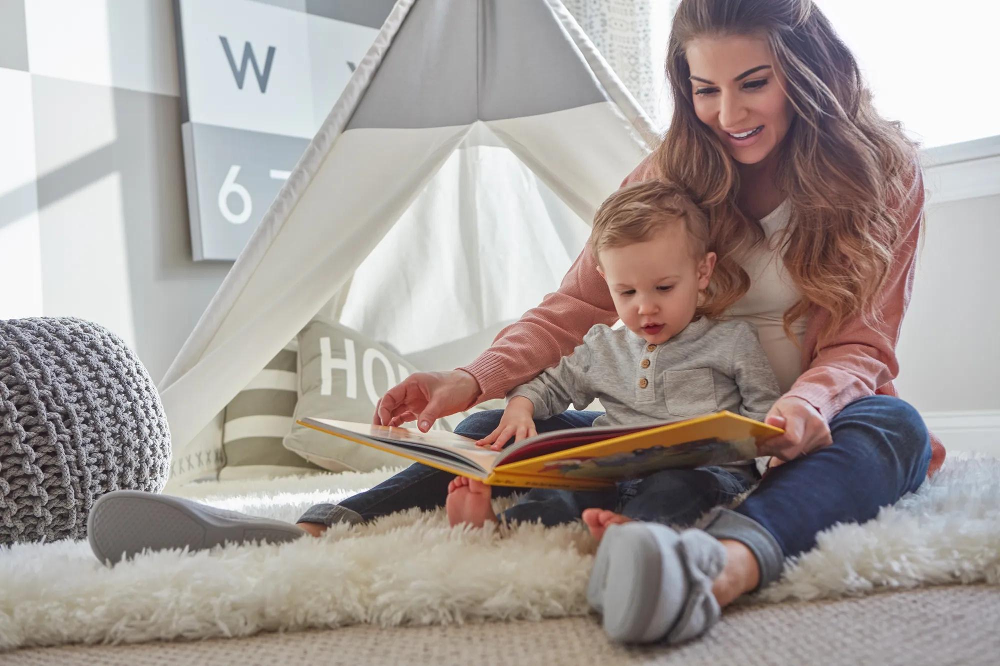 Mother and son reading in bedroom