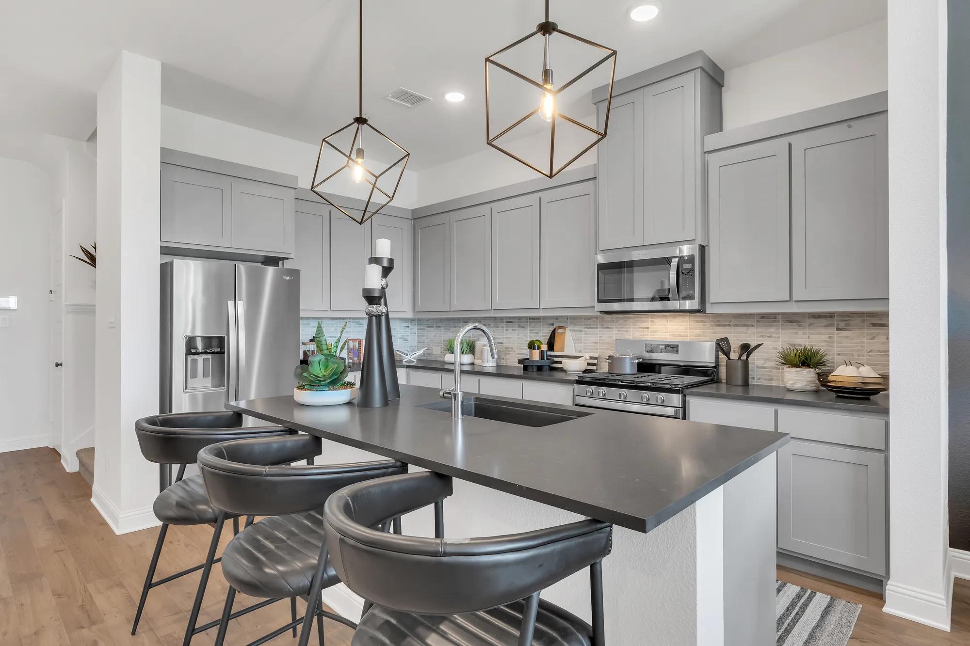 New townhome kitchen with gray countertops and kitchen island