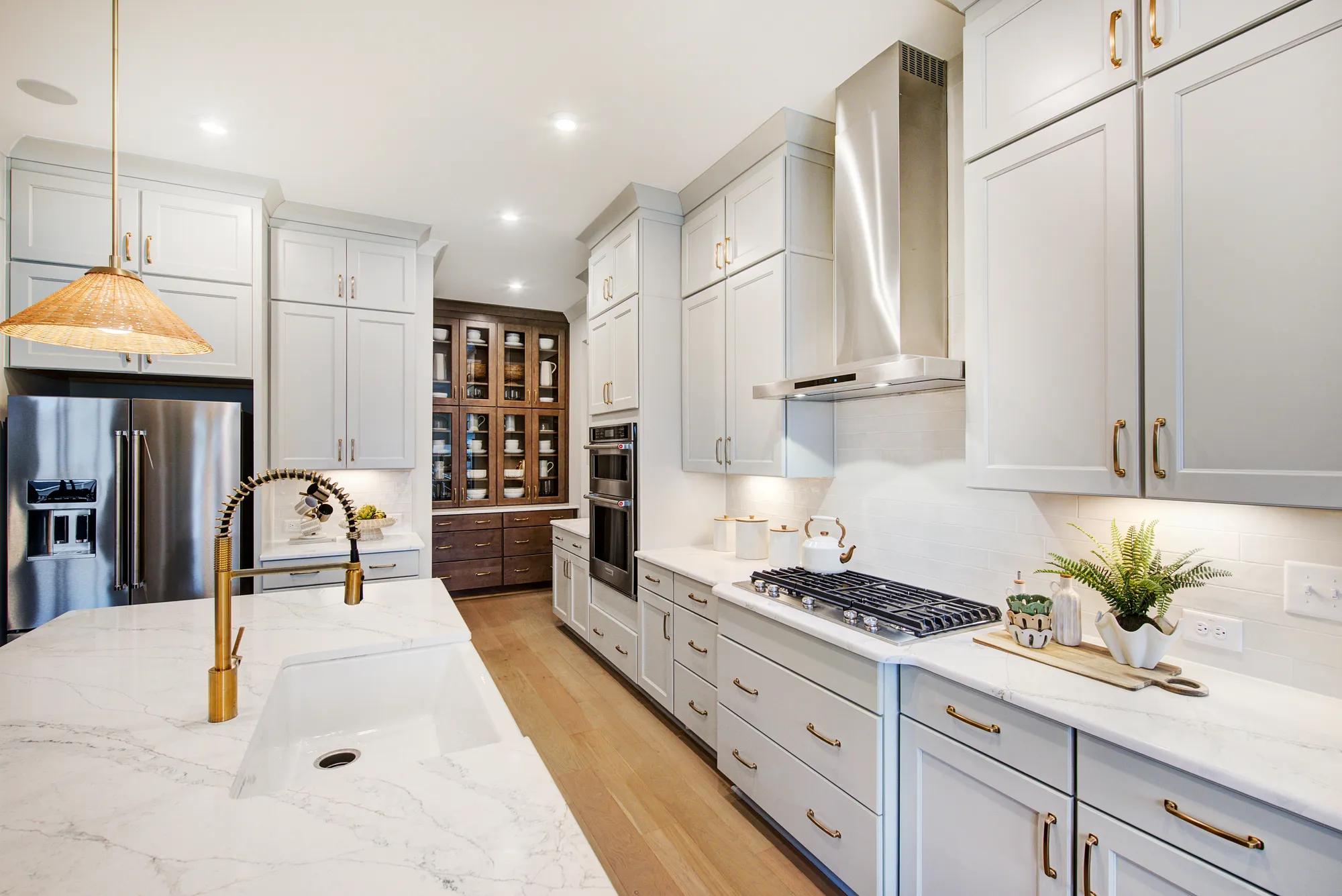Custom home kitchen with dark wood built-in hutch with glass front cabinets