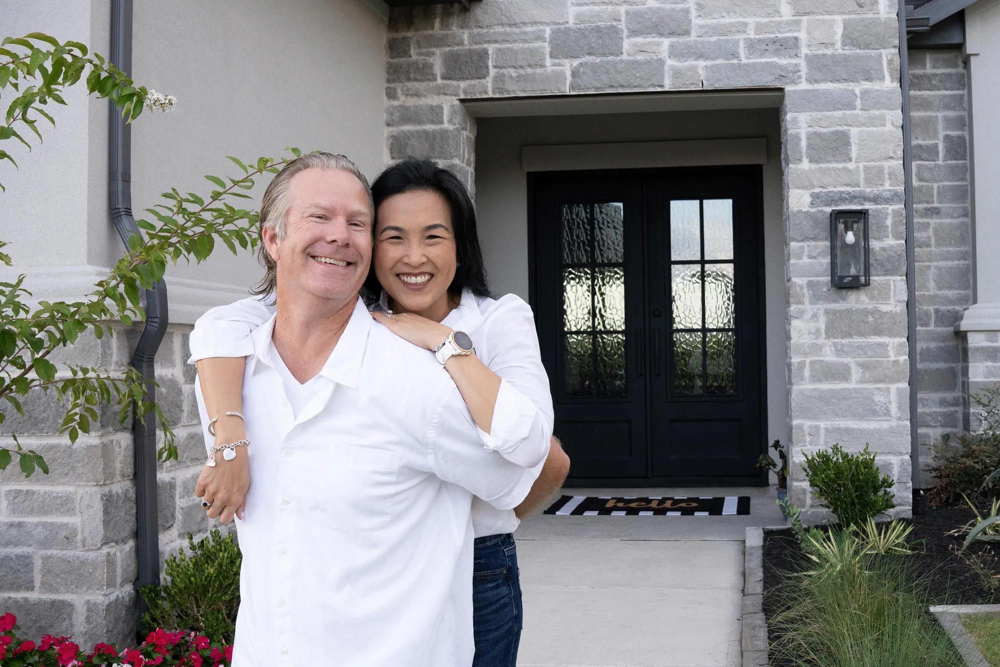 New homeowners enjoying the beautiful front yard of their gorgeous Lynmar style home