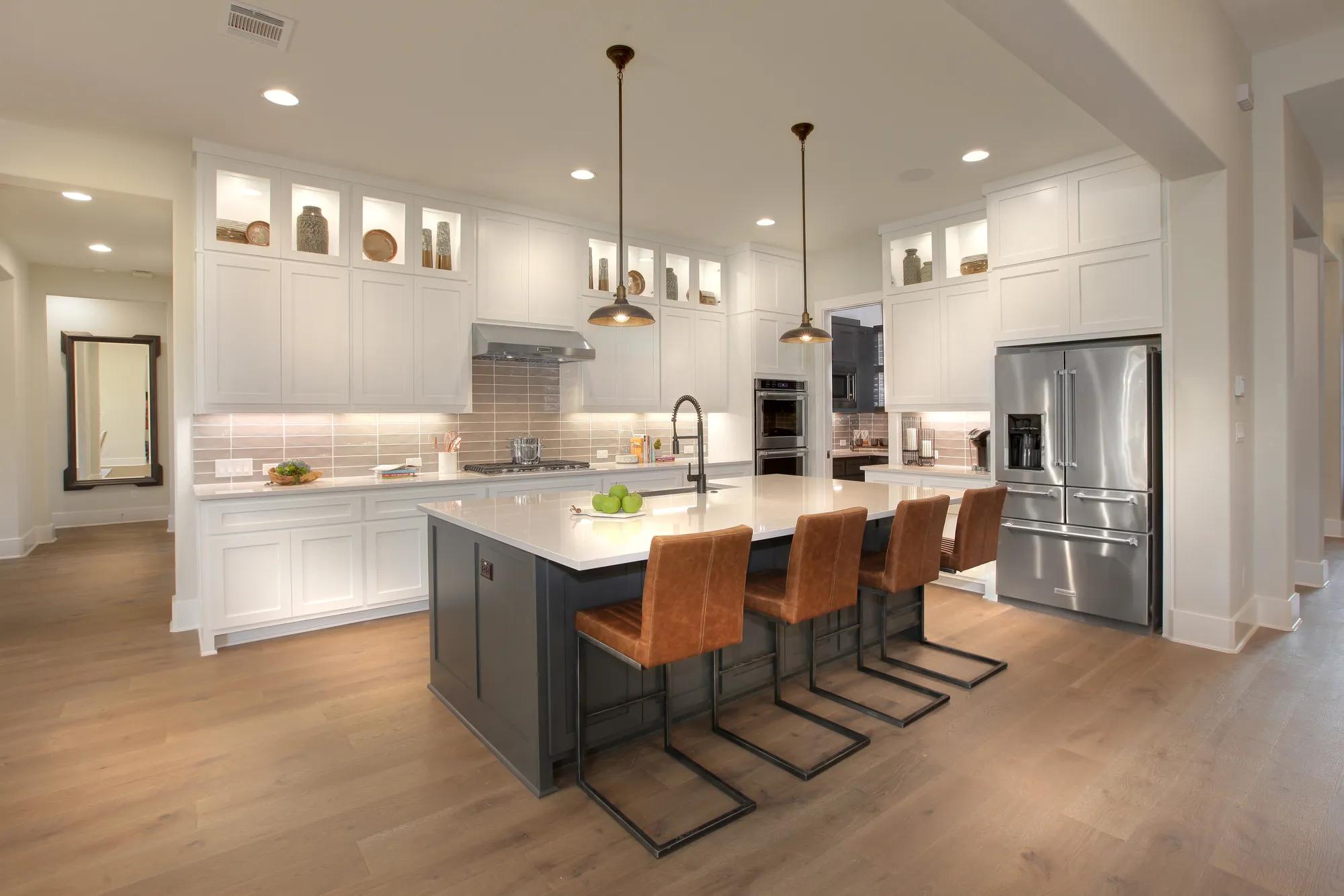 Kitchen with white cabinets and contrasting dark gray island