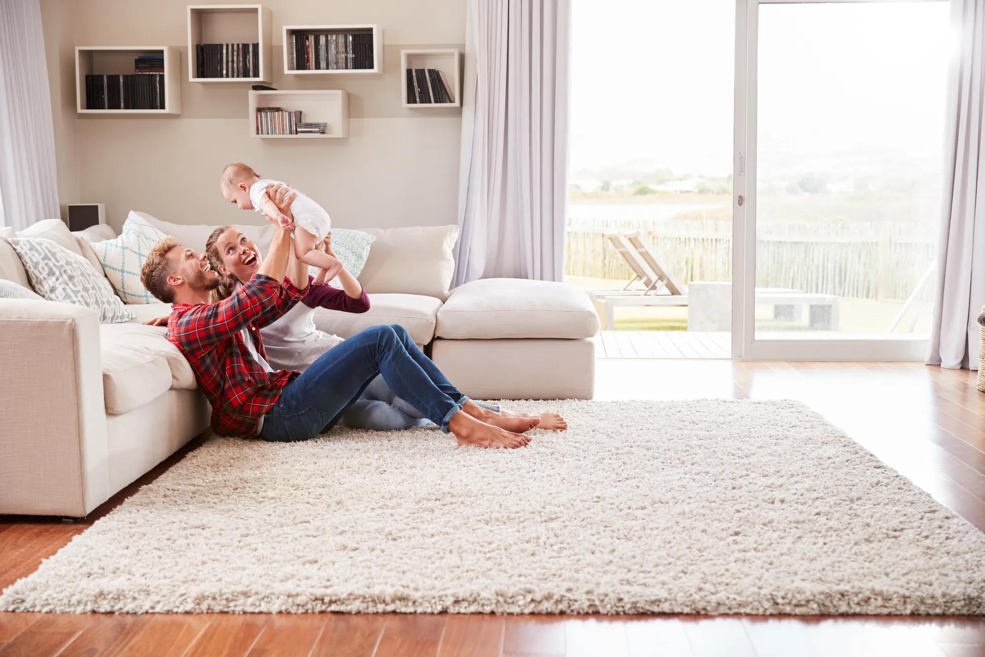Mother, father, and baby enjoying new home family room