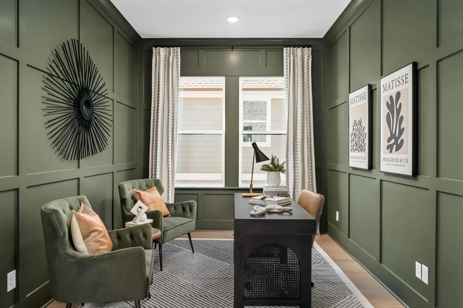 Custom home office with green color drenched wall paneling