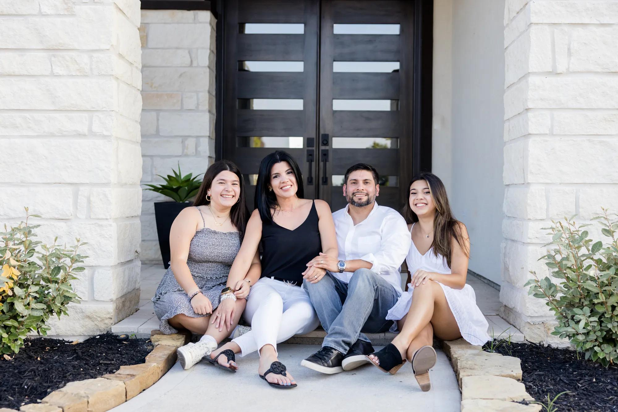 New homeowners enjoying their gorgeous front porch of their Lauren style home