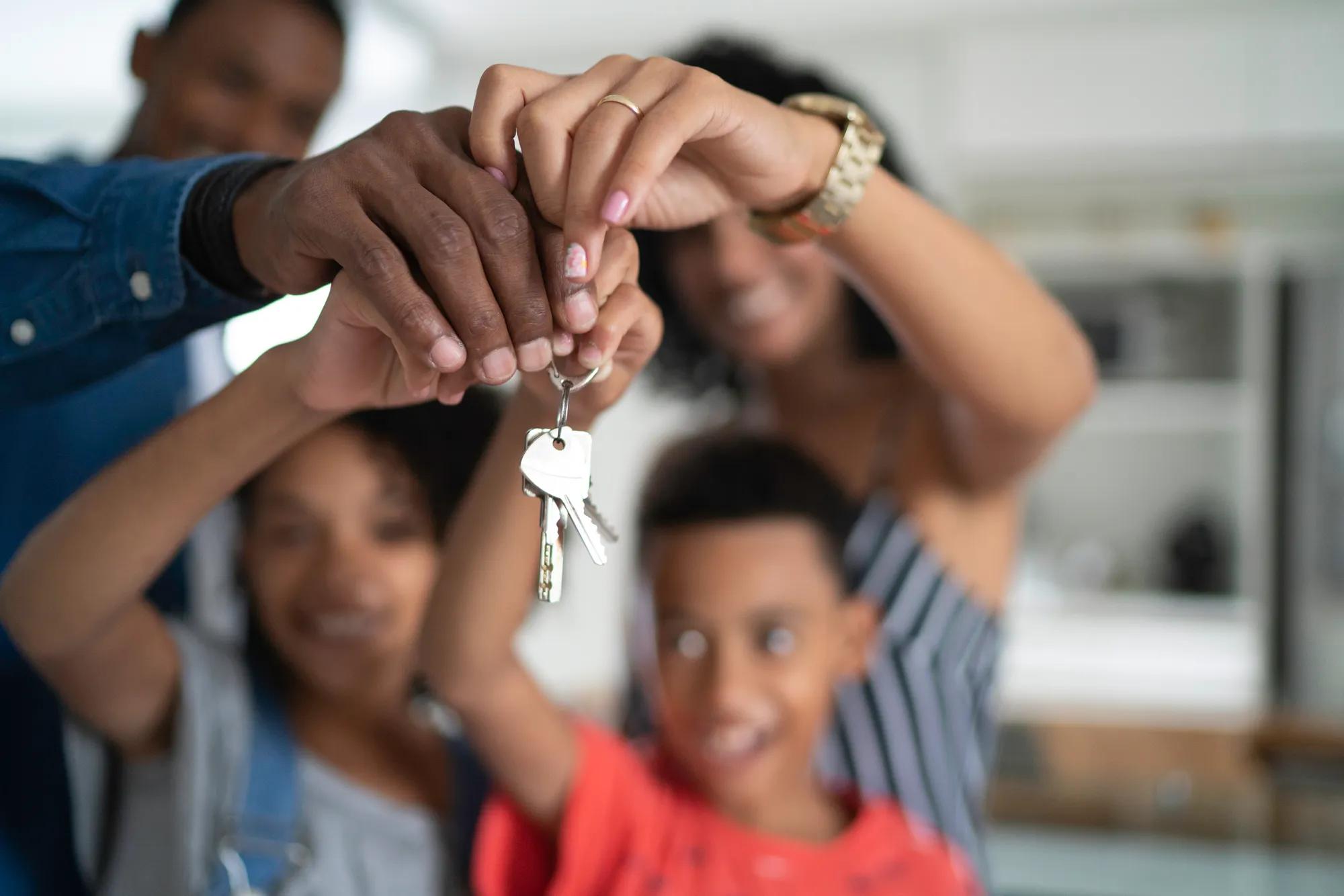 Family holding house keys