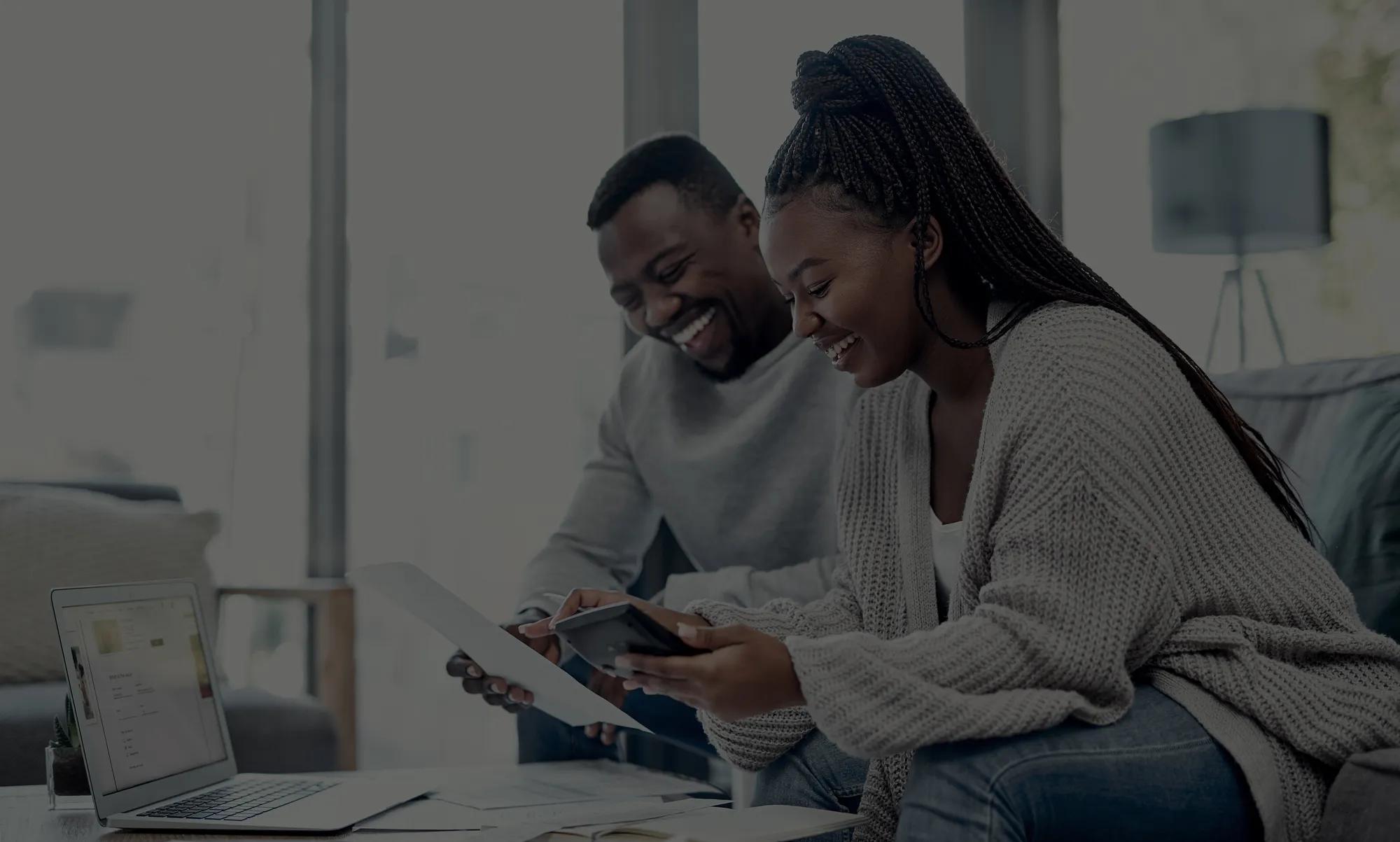 black couple on laptop financing darken