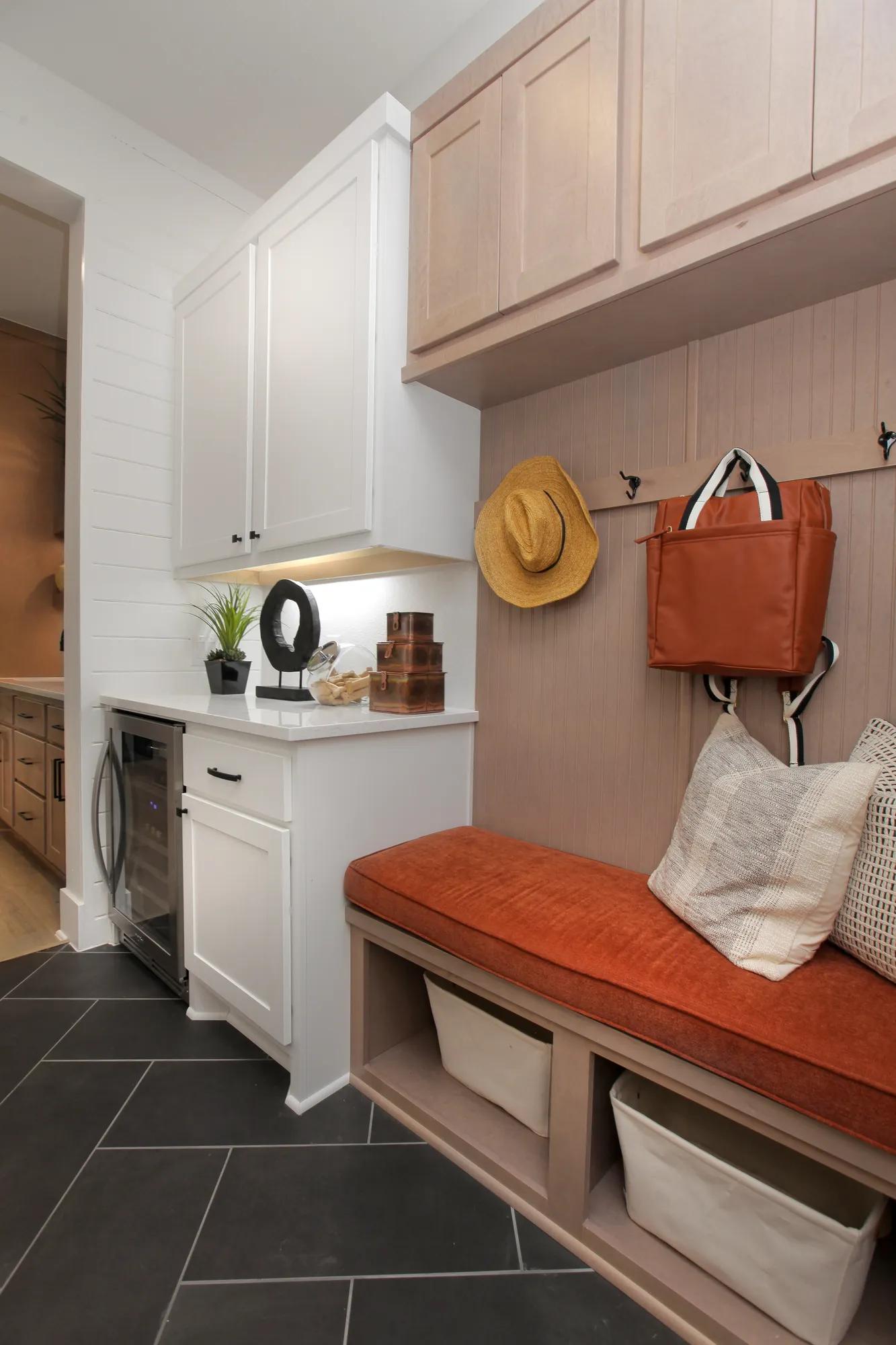 New home laundry room with family foyer bench and cabinet storage