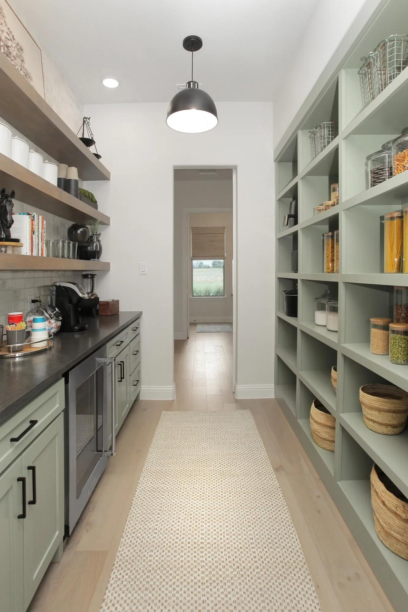 custom walk-in pantry with cabinets and shelves