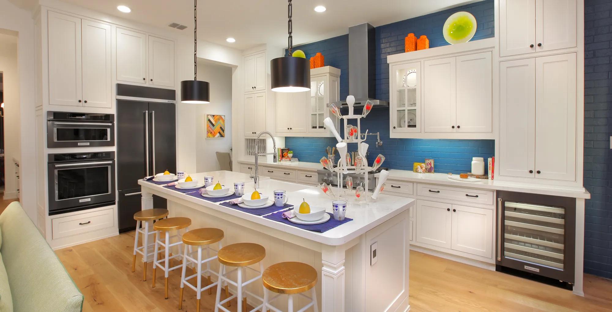 Kitchen with white cabinets and blue brick backsplash