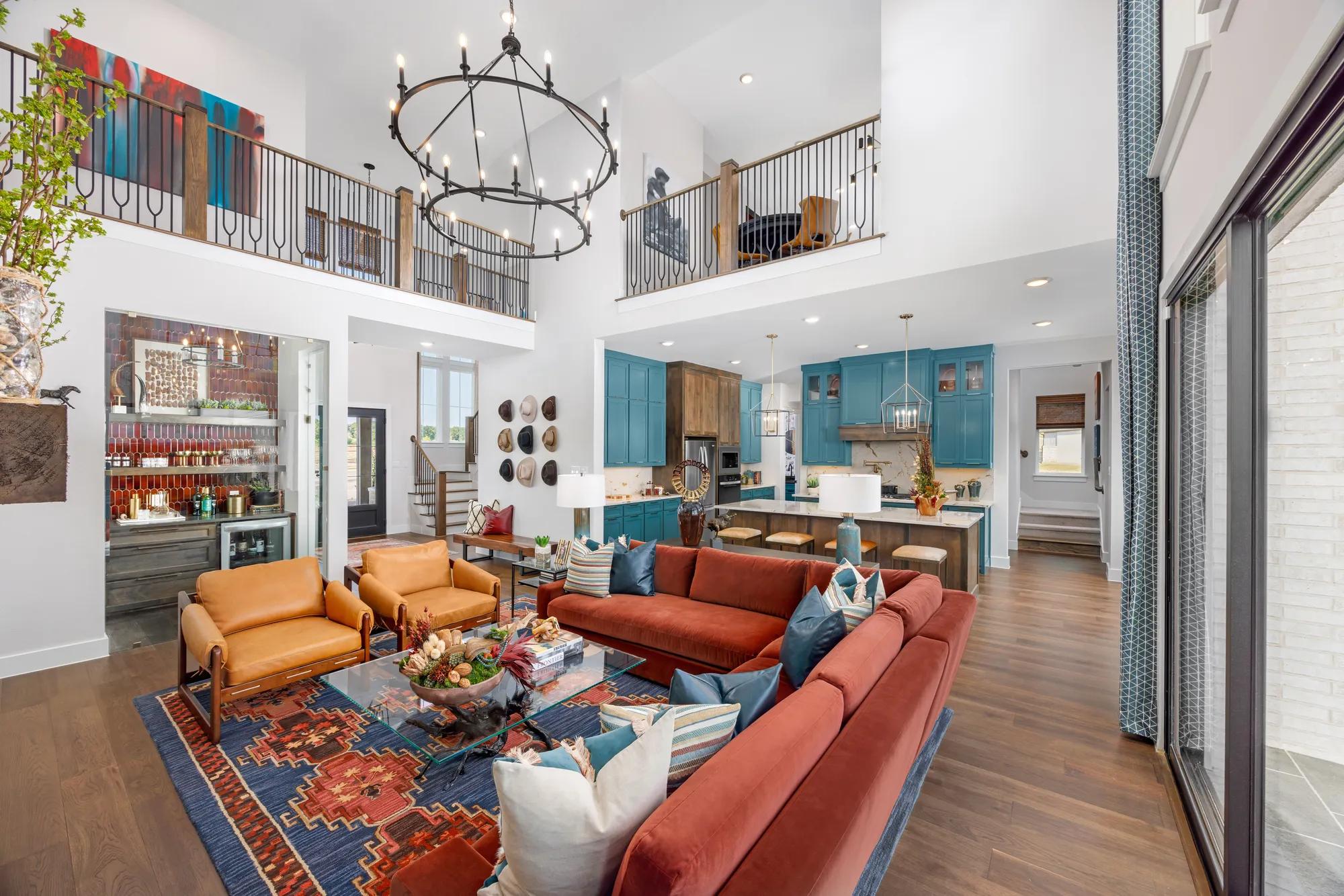 Custom home open floor plan with two-story family room, wine bar, and kitchen with island