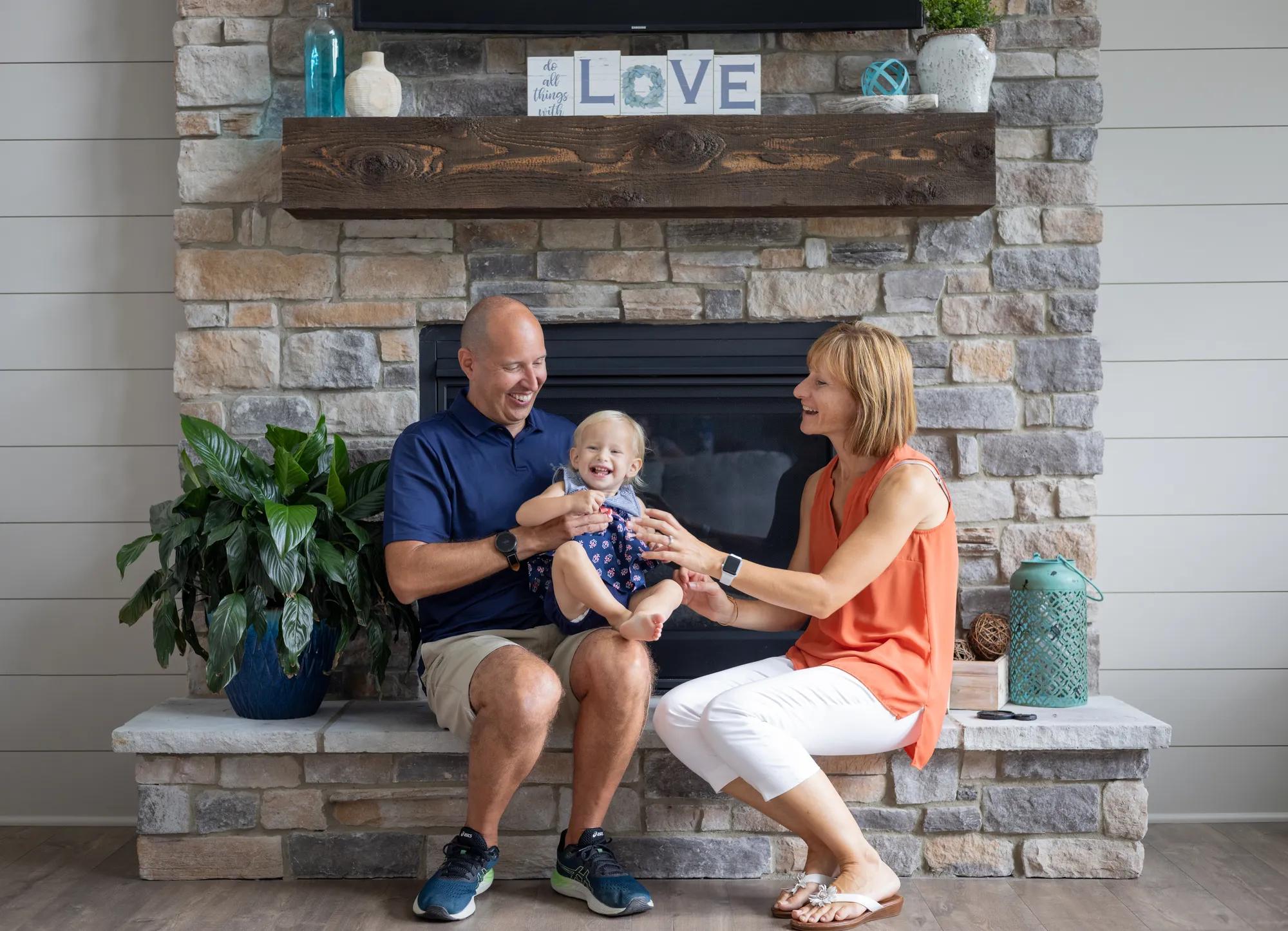 New Drees homeowners enjoying the charming Buchanan stone fireplace