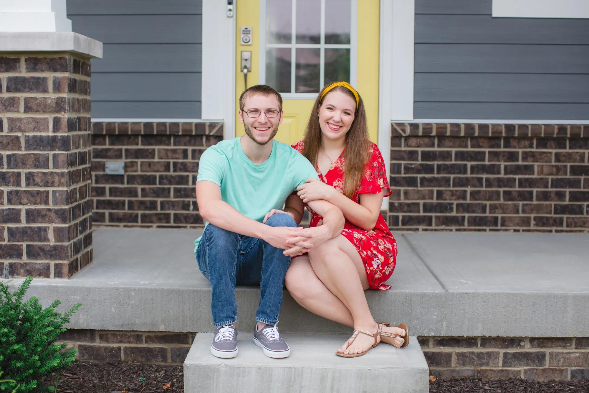 New homeowners enjoying a beautiful day from their Drees Home front porch