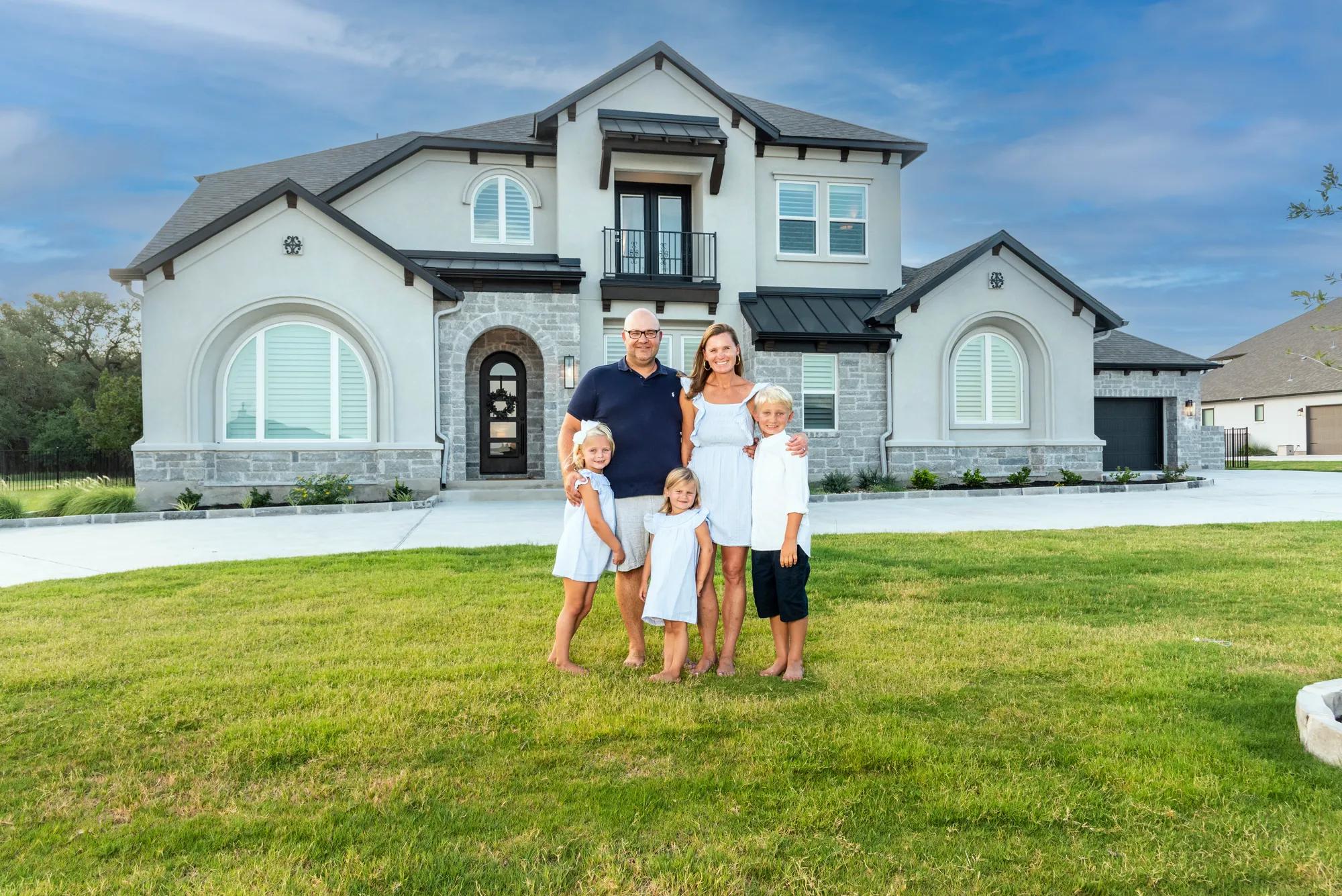 New homeowners outside of their Drees Home exterior