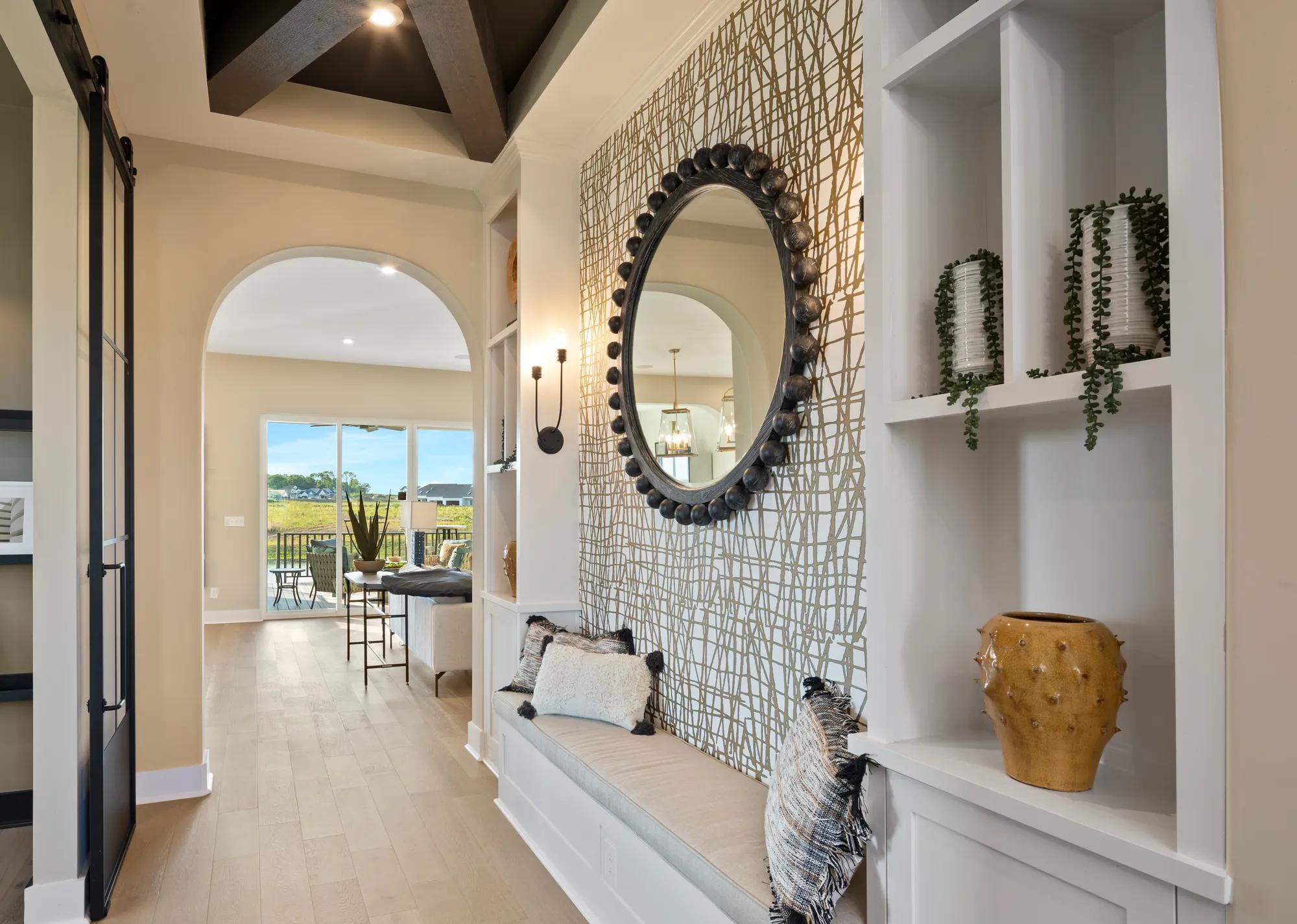 foyer with bench and built-in bookshelves