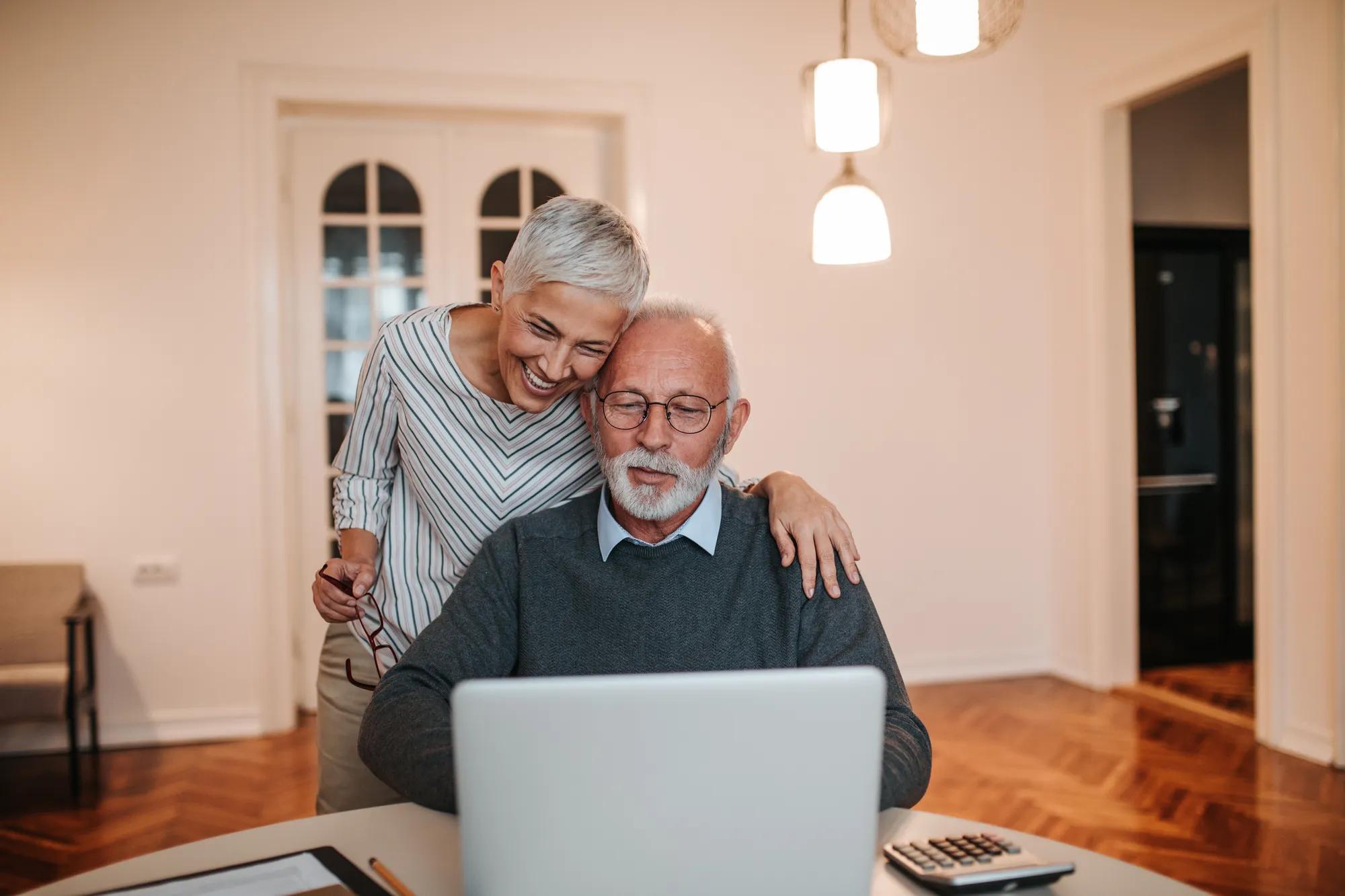 Couple looking at laptop in home