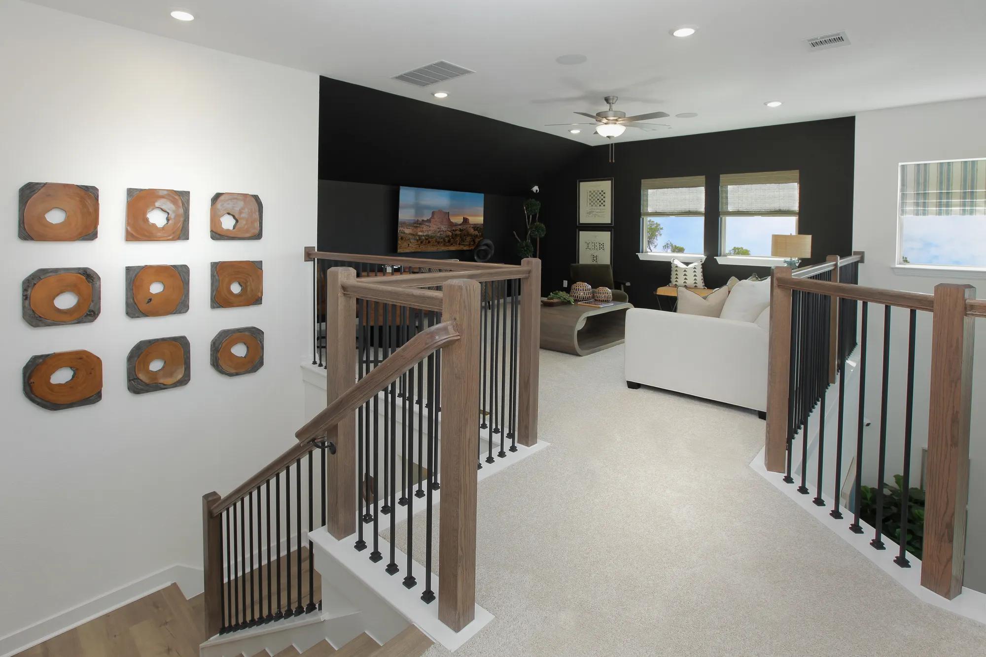 Custom home second story gameroom with modern wood and metal railing