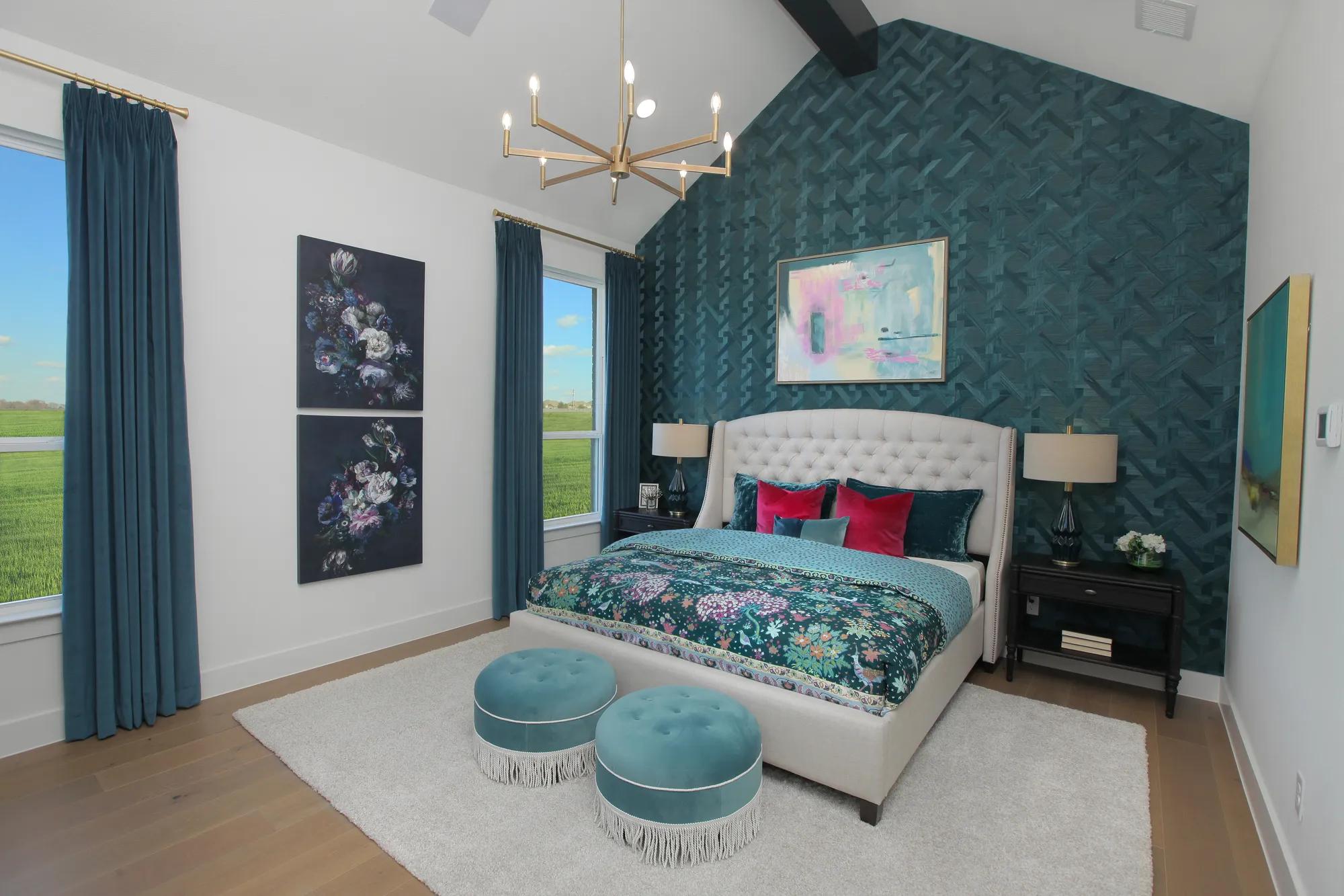 custom home primary bedroom with vaulted beam ceiling