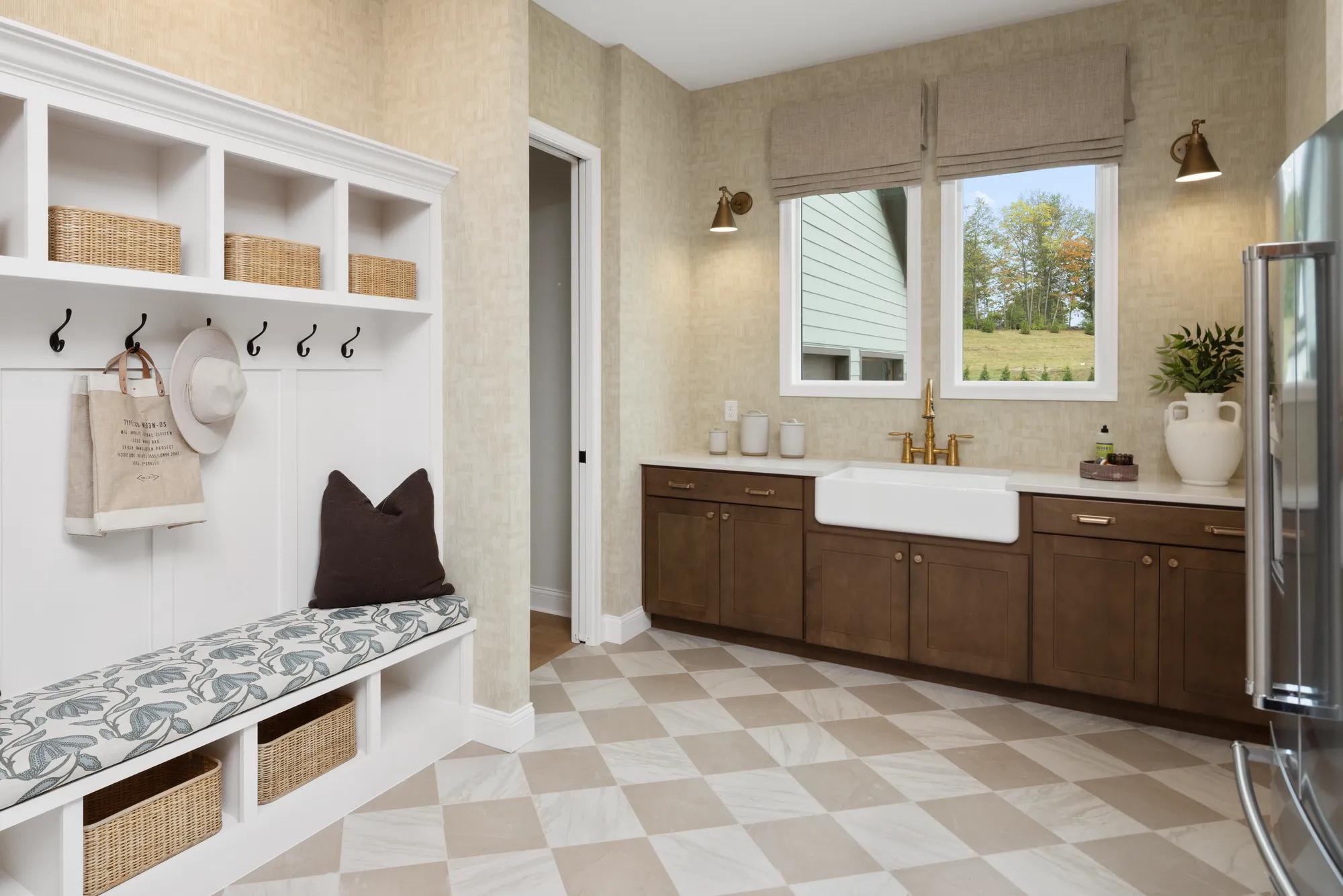 Custom home laundry room and mudroom with farm sink and wood cabinets