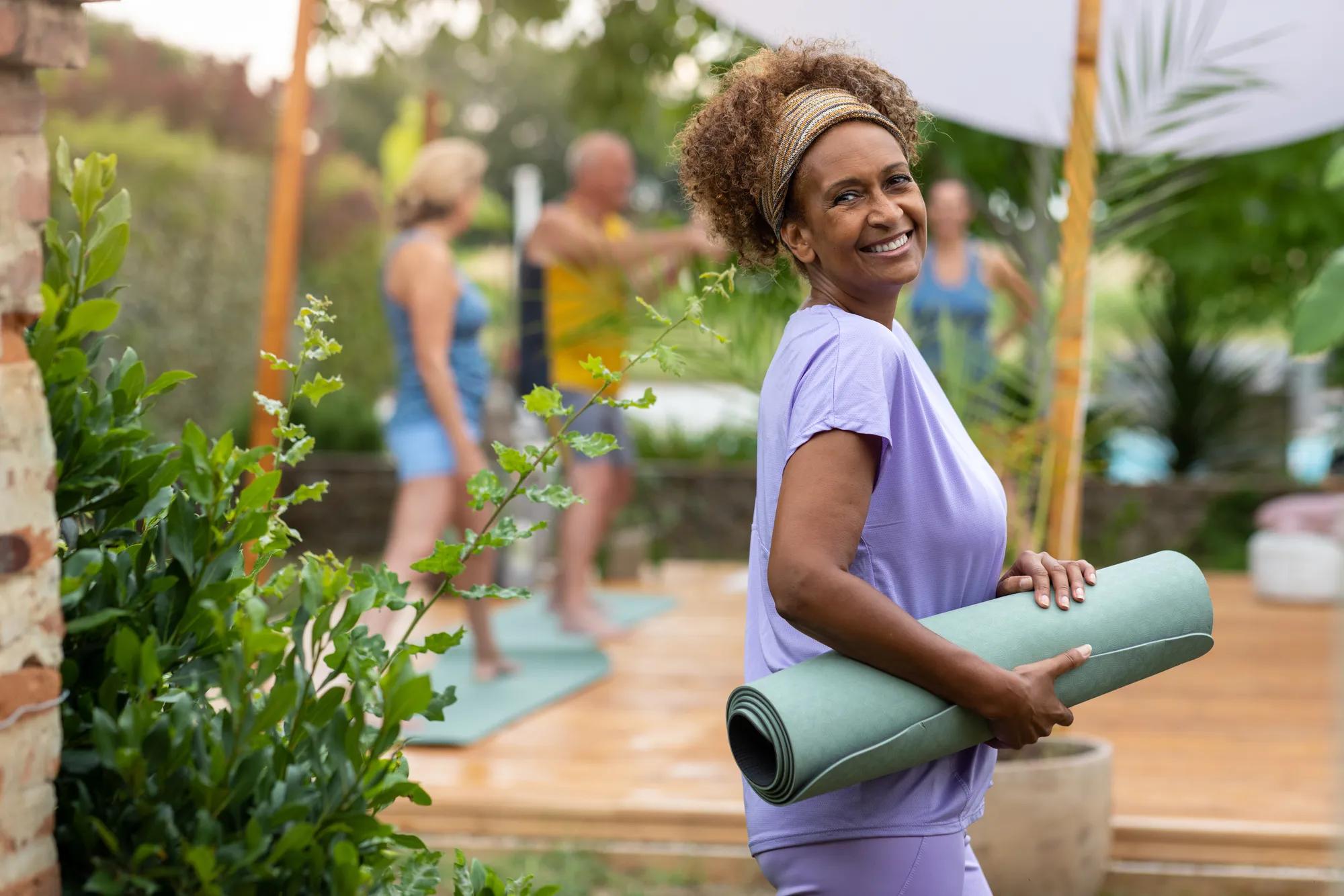 Woman joining outdoor exercise yoga class