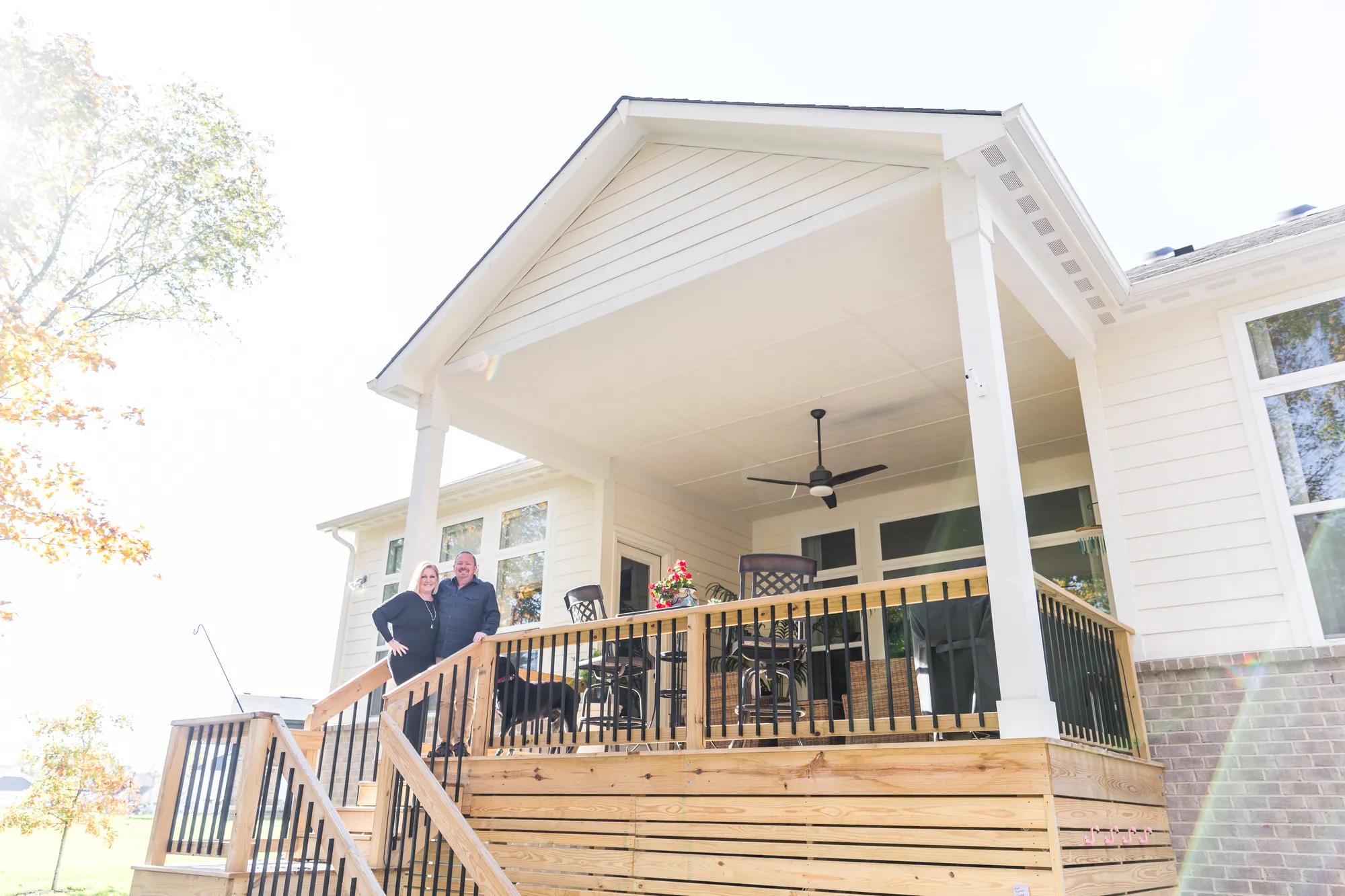 New homeowners adoring the view of their stunning Crestwood exterior