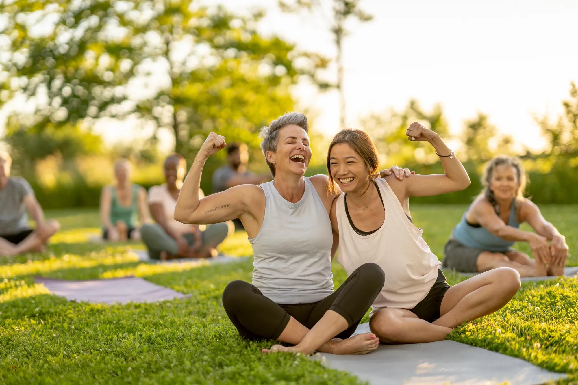 Women enjoying yoga in outdoor green space